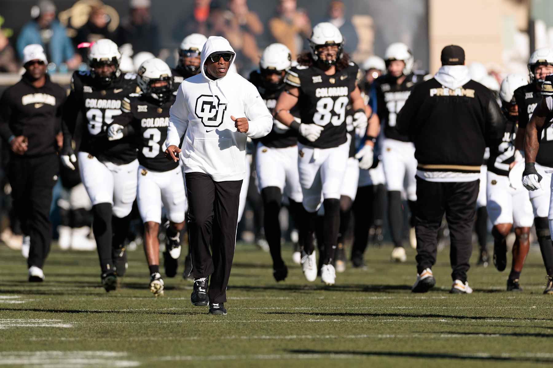 BOULDER, COLORADO - NOVEMBER 29: Head coach Deion Sanders of the Colorado Buffaloes runs out with his team prior to the game against the Oklahoma State Cowboys at Folsom Field on November 29, 2024 in Boulder, Colorado. (Photo by Andrew Wevers/Getty Images)