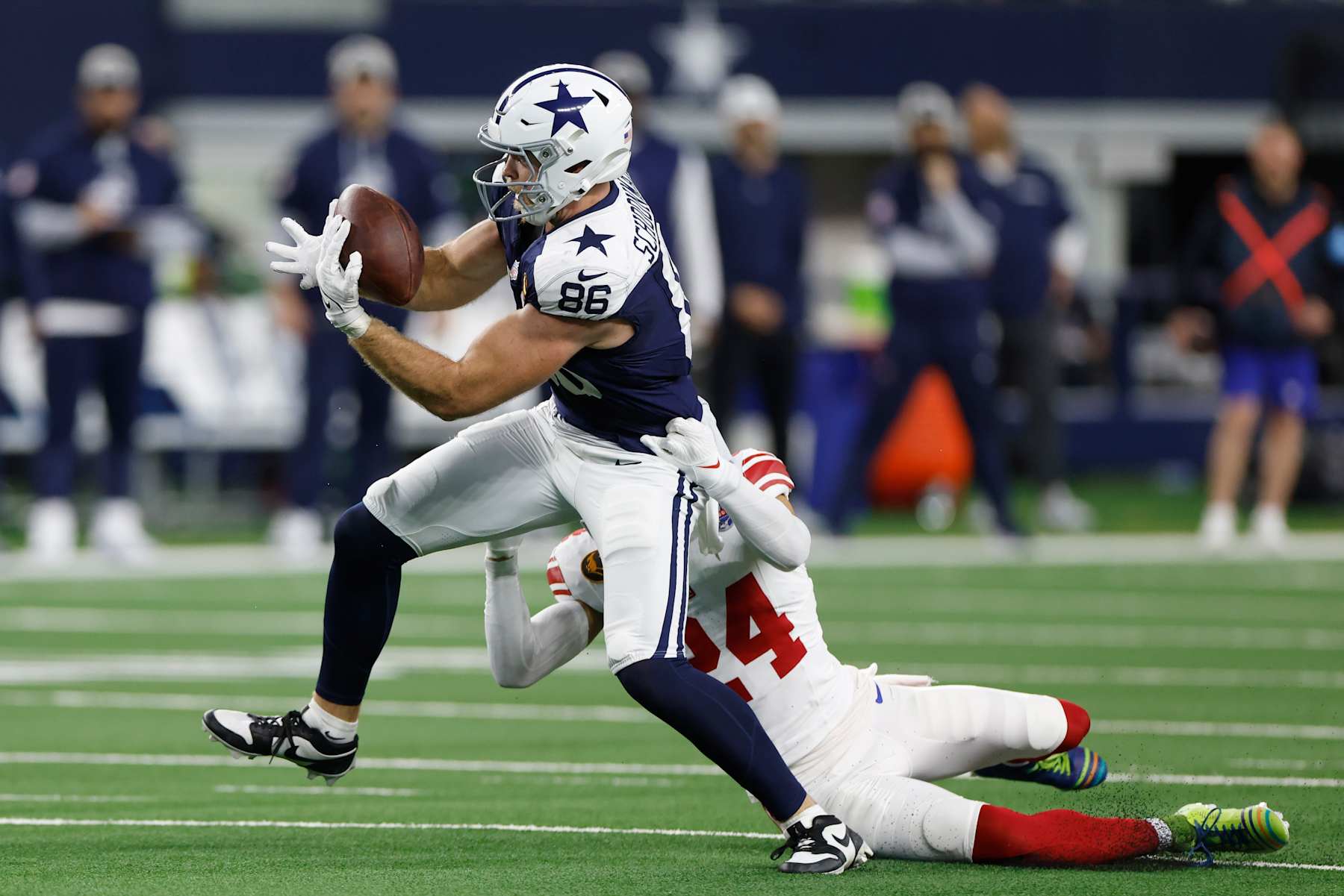 ARLINGTON, TEXAS - NOVEMBER 28: Luke Schoonmaker #86 of the Dallas Cowboys catches a pass against Dane Belton #24 of the New York Giants during the second quarter at AT&T Stadium on November 28, 2024 in Arlington, Texas. (Photo by Ron Jenkins/Getty Images)