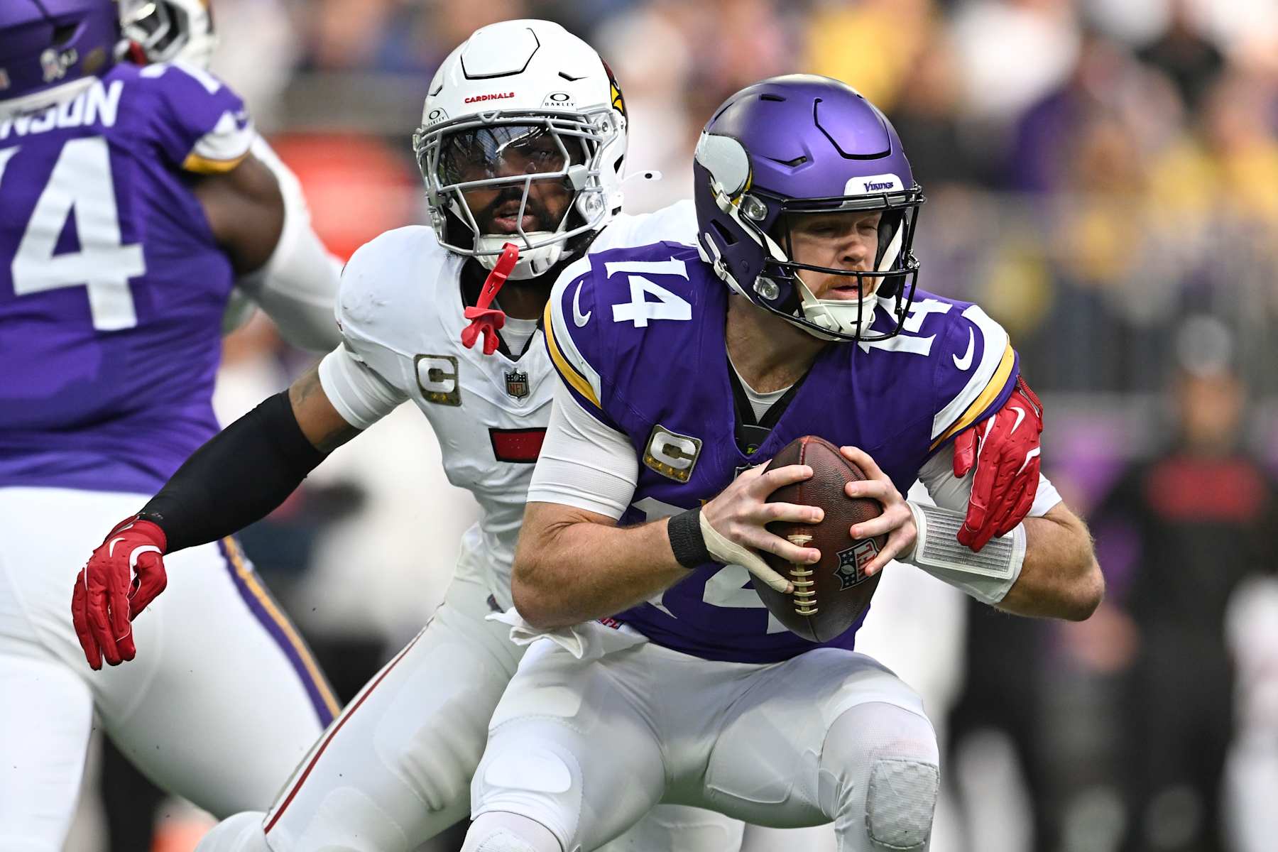 MINNEAPOLIS, MINNESOTA - DECEMBER 01: Quarterback Sam Darnold #14 of the Minnesota Vikings is sacked by Kyzir White #7 of the Arizona Cardinals during the second quarter of a game at U.S. Bank Stadium on December 01, 2024 in Minneapolis, Minnesota. (Photo by Stephen Maturen/Getty Images)