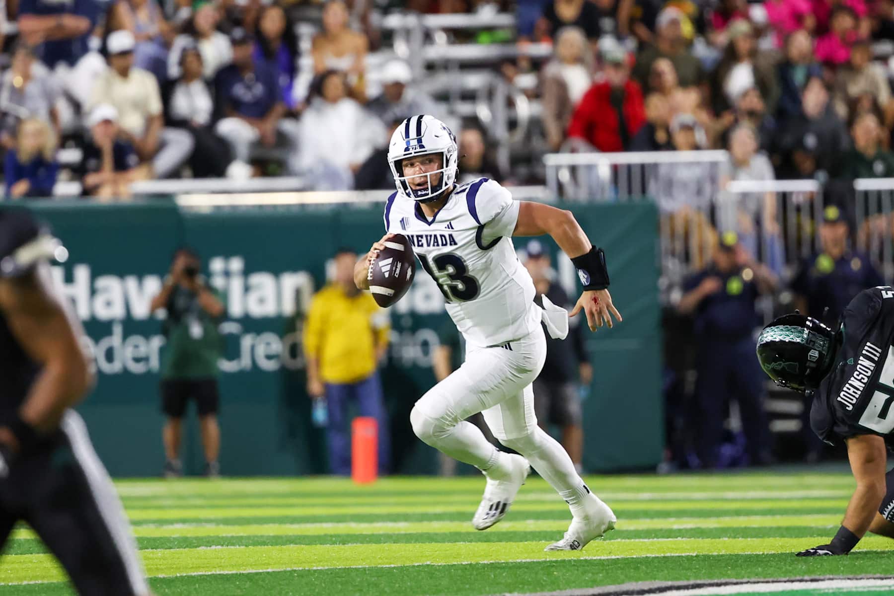HONOLULU, HAWAII - OCTOBER 26: Chubba Purdy #13 of the Nevada Wolfpack runs the ball as he is flushed from the pocket during the first half of the game against the Hawaii Rainbow Warriors at the Clarence T.C. Ching Athletics Complex on October 26, 2024 in Honolulu, Hawaii.  (Photo by Darryl Oumi/Getty Images)