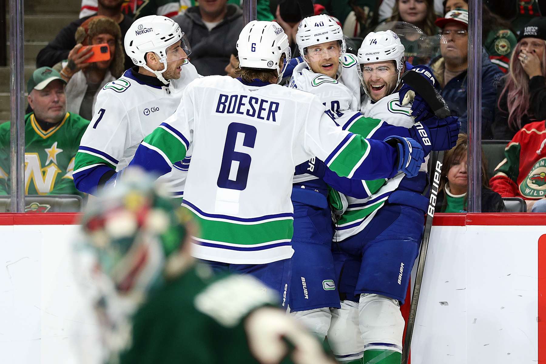 ST PAUL, MINNESOTA - DECEMBER 03: Jake DeBrusk #74 of the Vancouver Canucks (R) celebrates his goal against the Minnesota Wild with teammates in the second period at Xcel Energy Center on December 03, 2024 in St Paul, Minnesota. (Photo by David Berding/Getty Images)