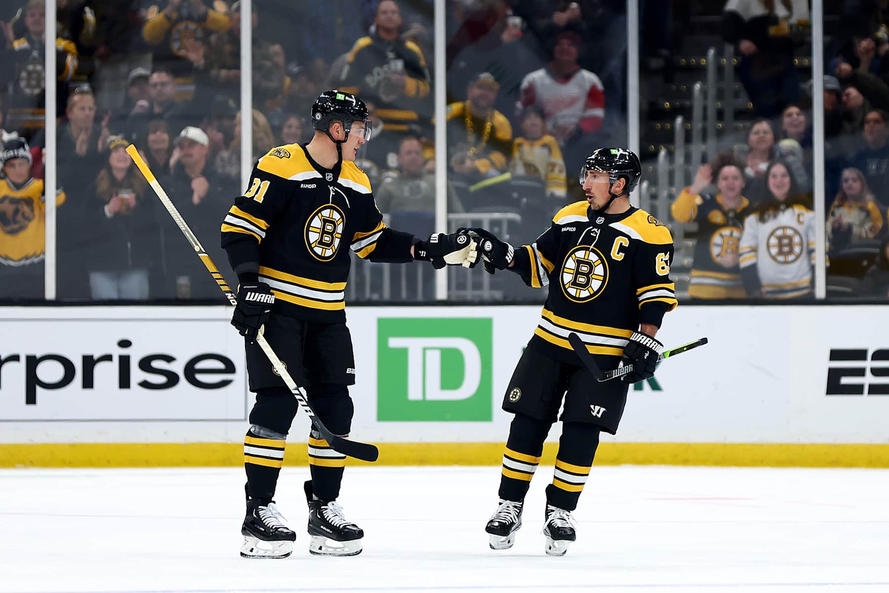 BOSTON, MASSACHUSETTS - DECEMBER 03: Nikita Zadorov #91 of the Boston Bruins celebrates with Brad Marchand #63 after scoring a goal against the Detroit Red Wings during the first period at TD Garden on December 03, 2024 in Boston, Massachusetts. (Photo by Maddie Meyer/Getty Images)