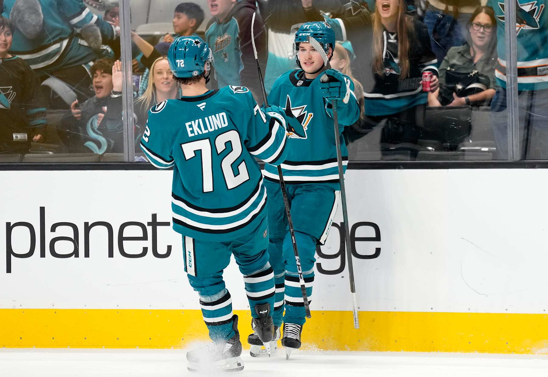 SAN JOSE, CALIFORNIA - NOVEMBER 29: Macklin Celebrini #71 of the San Jose Sharks is congratulated by William Eklund #72 after Celebrini scored a goal against the Seattle Kraken during the second period of an NHL hockey game at SAP Center on November 29, 2024 in San Jose, California. (Photo by Thearon W. Henderson/Getty Images)