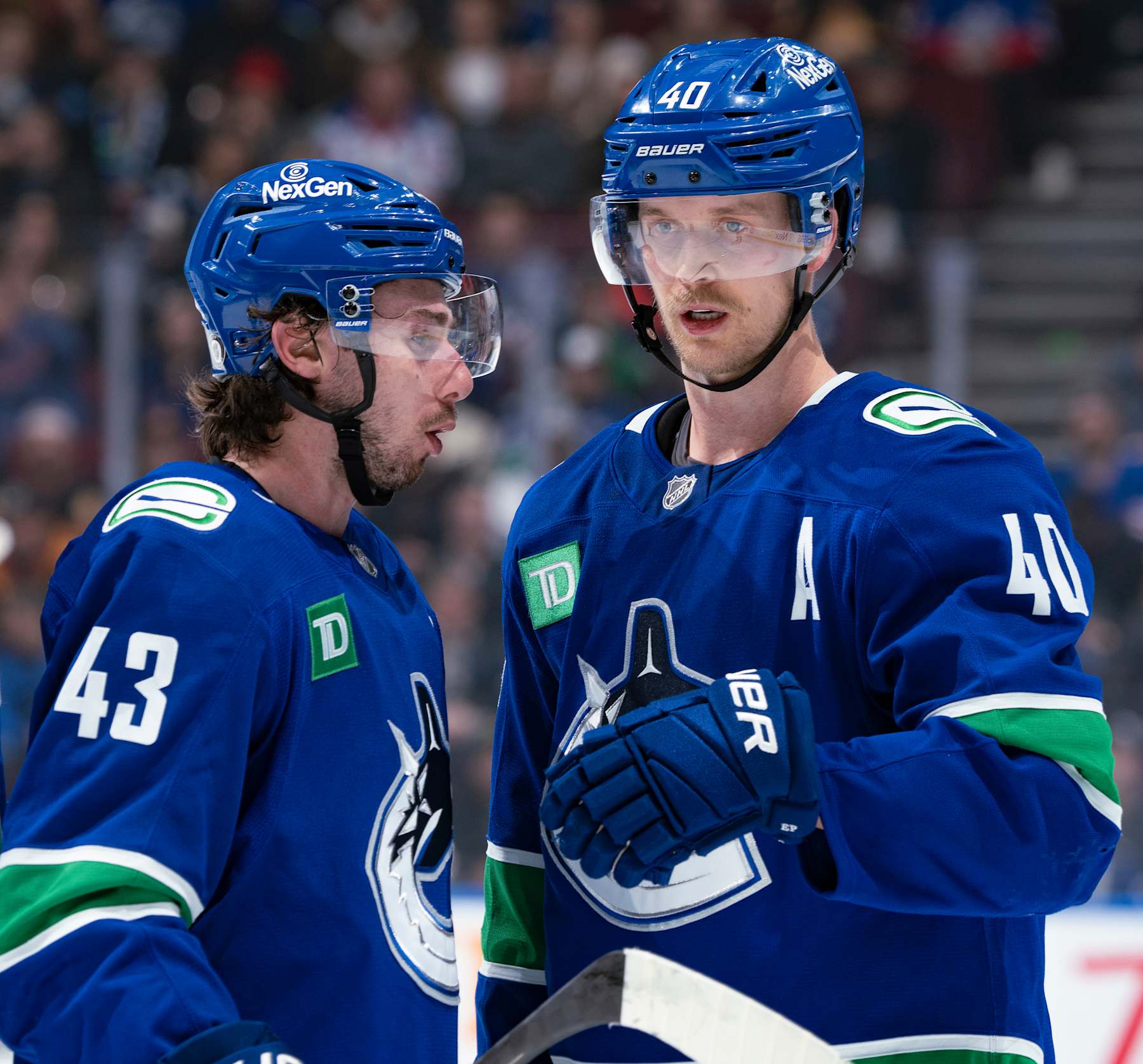 VANCOUVER, CANADA - NOVEMBER 19: Elias Pettersson #40 and Quinn Hughes #43 of the Vancouver Canucks talk during their NHL game against the New York Rangers at Rogers Arena on November 19, 2024 in Vancouver, British Columbia, Canada. (Photo by Jeff Vinnick/NHLI via Getty Images)