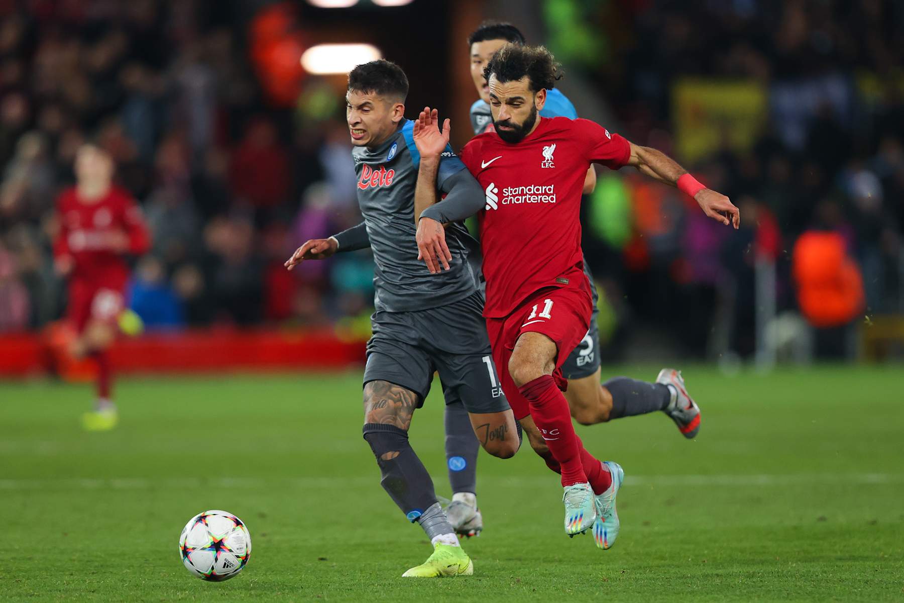 LIVERPOOL, ENGLAND - NOVEMBER 01: Mohamed Salah of Liverpool battles for possession with Mathias Olivera of Napoli during the UEFA Champions League group A match between Liverpool FC and SSC Napoli at Anfield on November 01, 2022 in Liverpool, England. (Photo by James Gill - Danehouse/Getty Images)