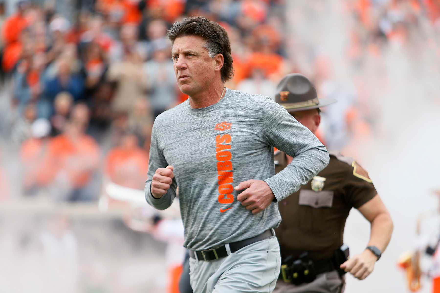 STILLWATER, OK - NOVEMBER 2: Head coach Mike Gundy of the Oklahoma State Cowboys runs onto the field for a game against the Arizona State Sun Devils at Boone Pickens Stadium on November 2, 2024 in Stillwater, Oklahoma. Arizona State won 42-21. (Photo by Brian Bahr/Getty Images)