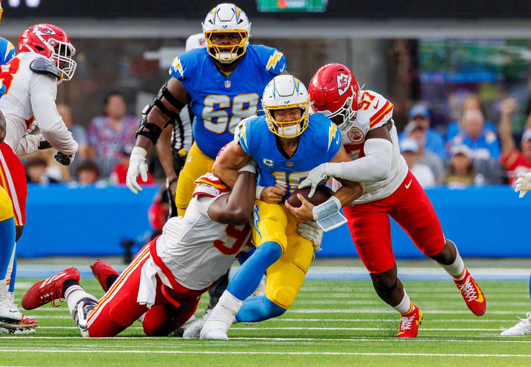 INGLEWOOD, CA - SEPTEMBER 29, 2024: Los Angeles Chargers quarterback Justin Herbert (10) is sacked by Kansas City Chiefs defensive tackle Chris Jones (95) and Kansas City Chiefs defensive end Felix Anudike-Uzomah (97) in the fourth quarter at the So-Fi Stadium on September 29, 2024 in Inglewood, California. (Gina Ferazzi / Los Angeles Times via Getty Images)