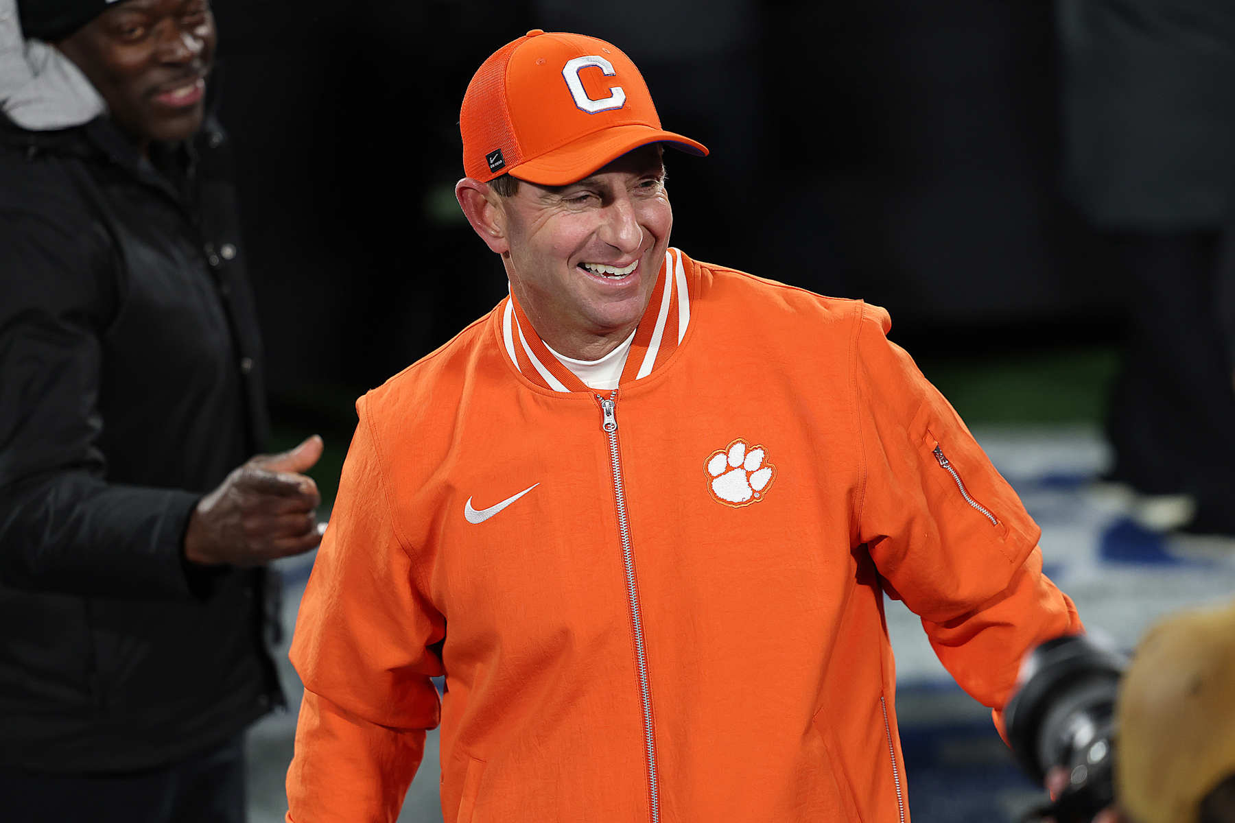 CHARLOTTE, NC - DECEMBER 07: Clemson Tigers head coach Dabo Swinney is all smiles after the win as he makes his way to the podium during the ACC championship football game between the SMU Mustangs and the Clemson Tigers on December 7, 2024 at Bank of America Stadium in Charlotte N.C. (Photo by John Byrum/Icon Sportswire via Getty Images)