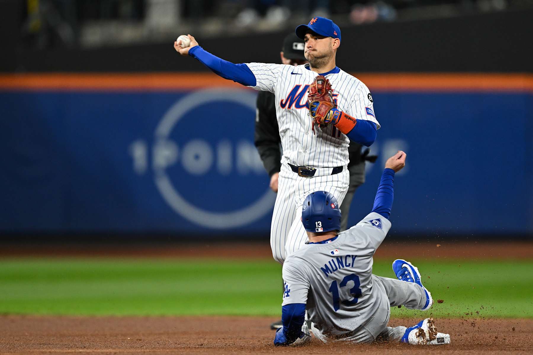 NEW YORK, NY - OCTOBER 17: Jose Iglesias #11 of the New York Mets throws over Max Muncy #13 of the Los Angeles Dodgers for an out in the second inning during Game 4 of the NLCS presented by loanDepot between the Los Angeles Dodgers and the New York Mets at Citi Field on Thursday, October 17, 2024 in New York, New York. (Photo by Drew Hallowell/MLB Photos via Getty Images)