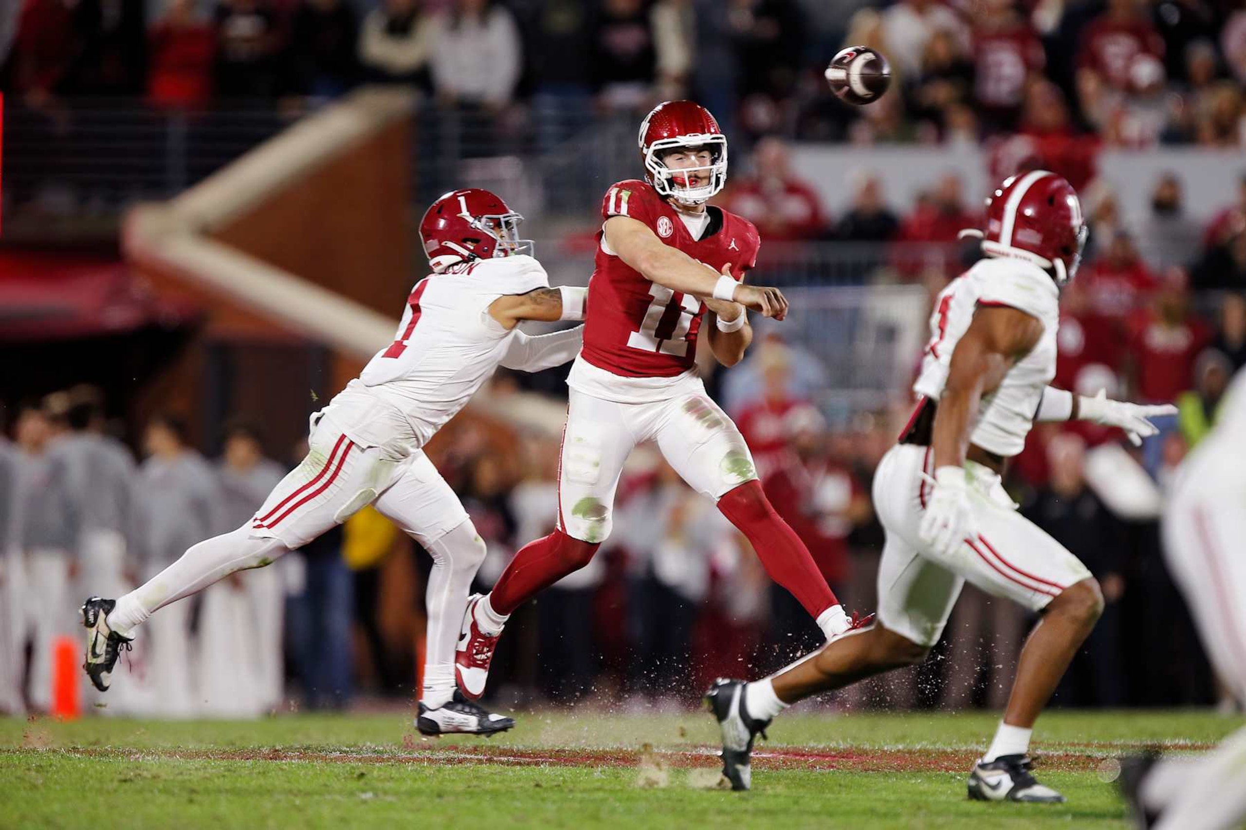 NORMAN, OKLAHOMA - NOVEMBER 23:  Quarterback Jackson Arnold #11 of the Oklahoma Sooners throws under pressure from cornerback Domani Jackson #1 of the Alabama Crimson Tide in the fourth quarter at Gaylord Family Oklahoma Memorial Stadium on November 23, 2024 in Norman, Oklahoma.  Oklahoma won 24-3. (Photo by Brian Bahr/Getty Images)