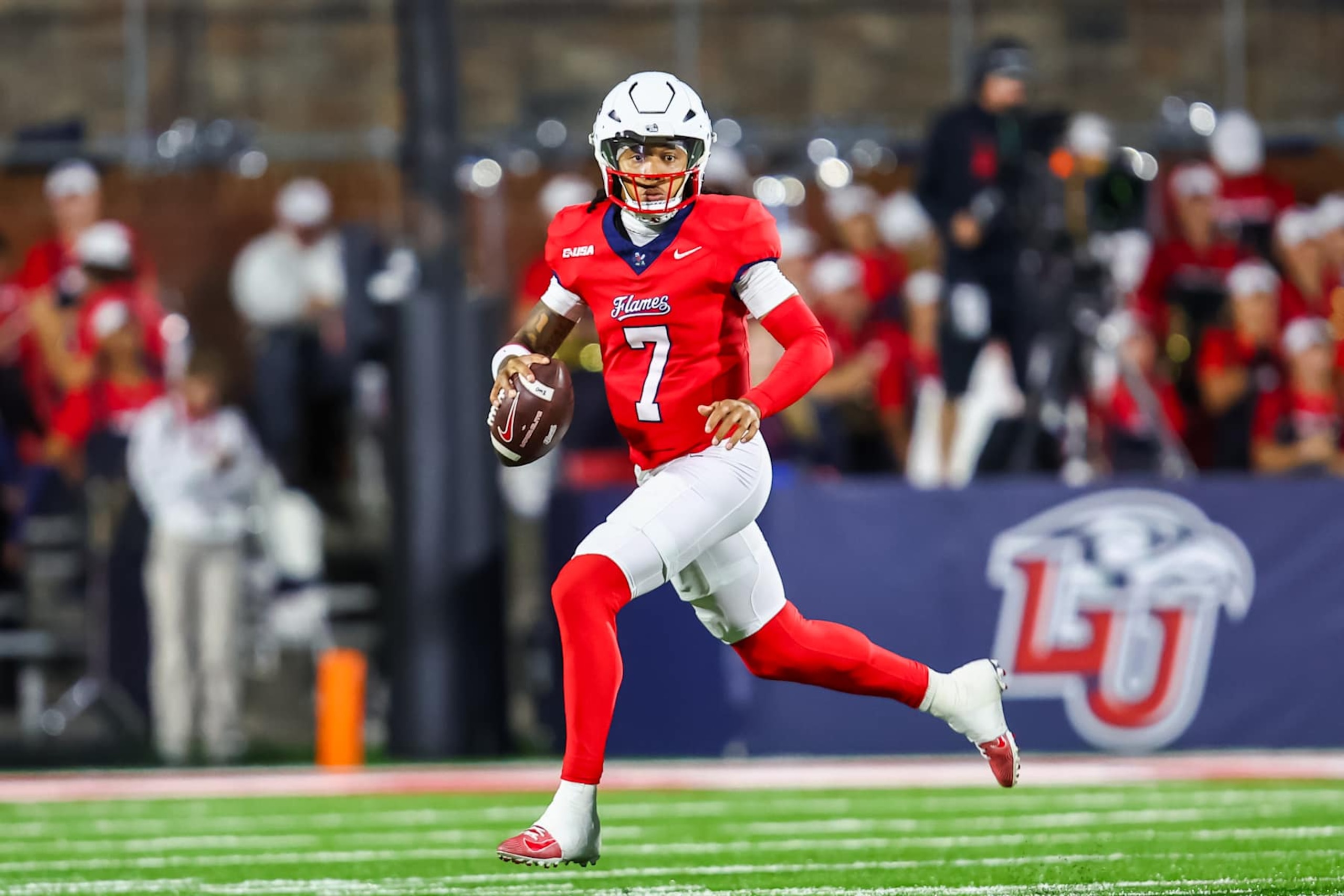 LYNCHBURG, VIRGINIA - OCTOBER 08: Kaidon Salter #7 of the Liberty Flames runs the ball during the first half of a football game against the Florida International University Panthers at Williams Stadium on October 08, 2024 in Lynchburg, Virginia.  (Photo by David Jensen/Getty Images)