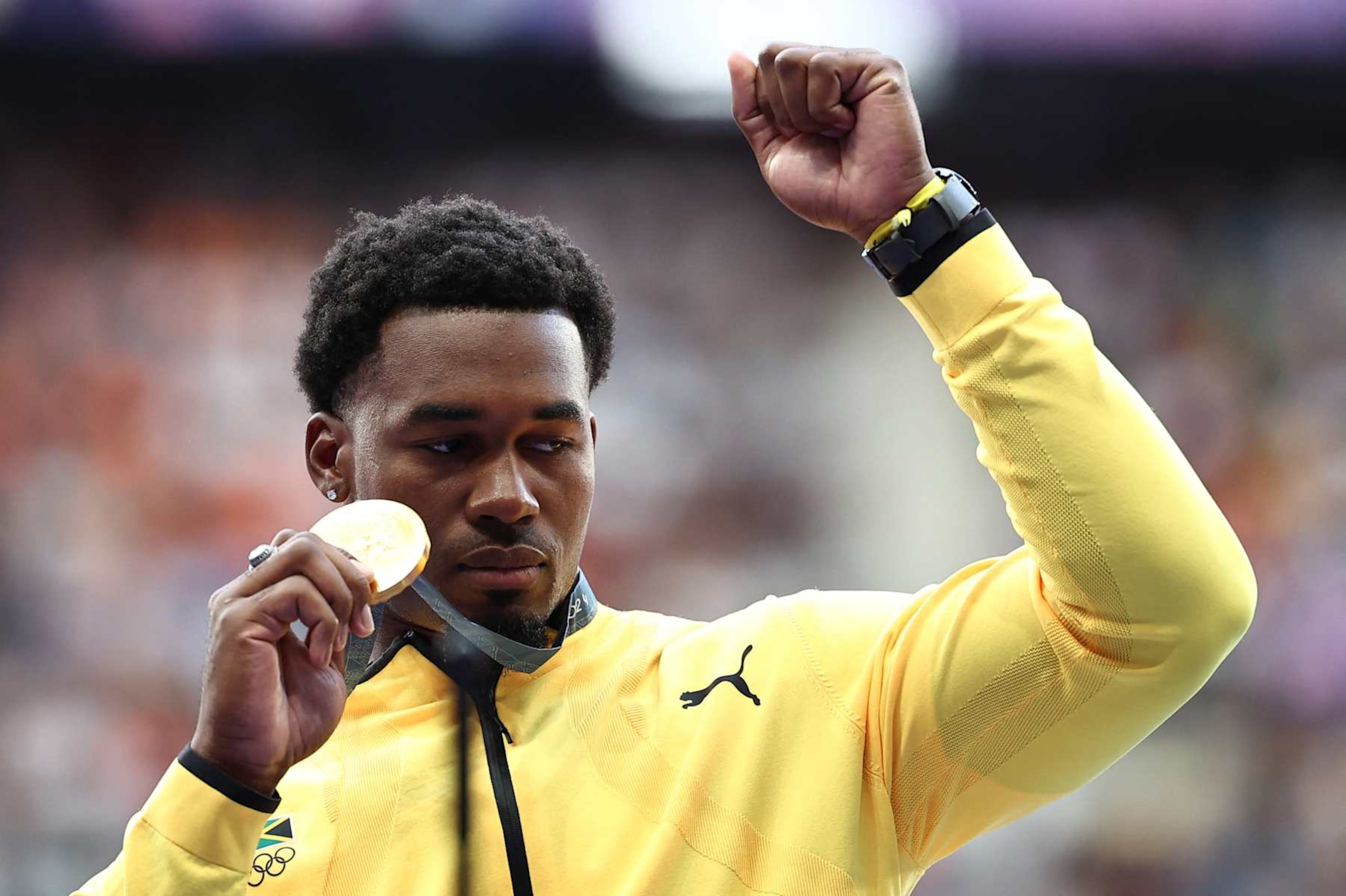 Gold medallist Jamaica's Roje Stona celebrates on the podium during the victory ceremony for the men's discus throw final athletics event at the Paris 2024 Olympic Games at Stade de France in Saint-Denis, north of Paris, on August 8, 2024. (Photo by Anne-Christine POUJOULAT / AFP) (Photo by ANNE-CHRISTINE POUJOULAT/AFP via Getty Images)