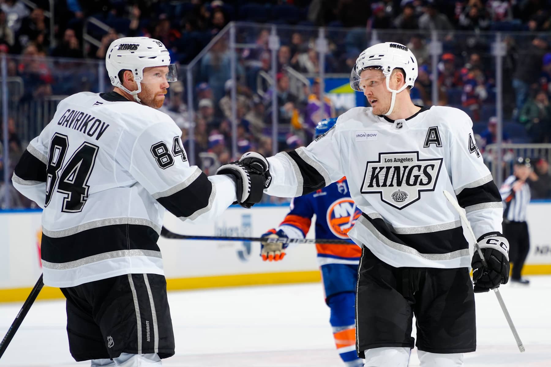 ELMONT, NEW YORK - DECEMBER 10: Vladislav Gavrikov #84 and Mikey Anderson #44 of the Los Angeles Kings celebrate the teams win against the New York Islanders at UBS Arena on December 10, 2024 in Elmont, New York. (Photo by Mike Stobe/NHLI via Getty Images)
