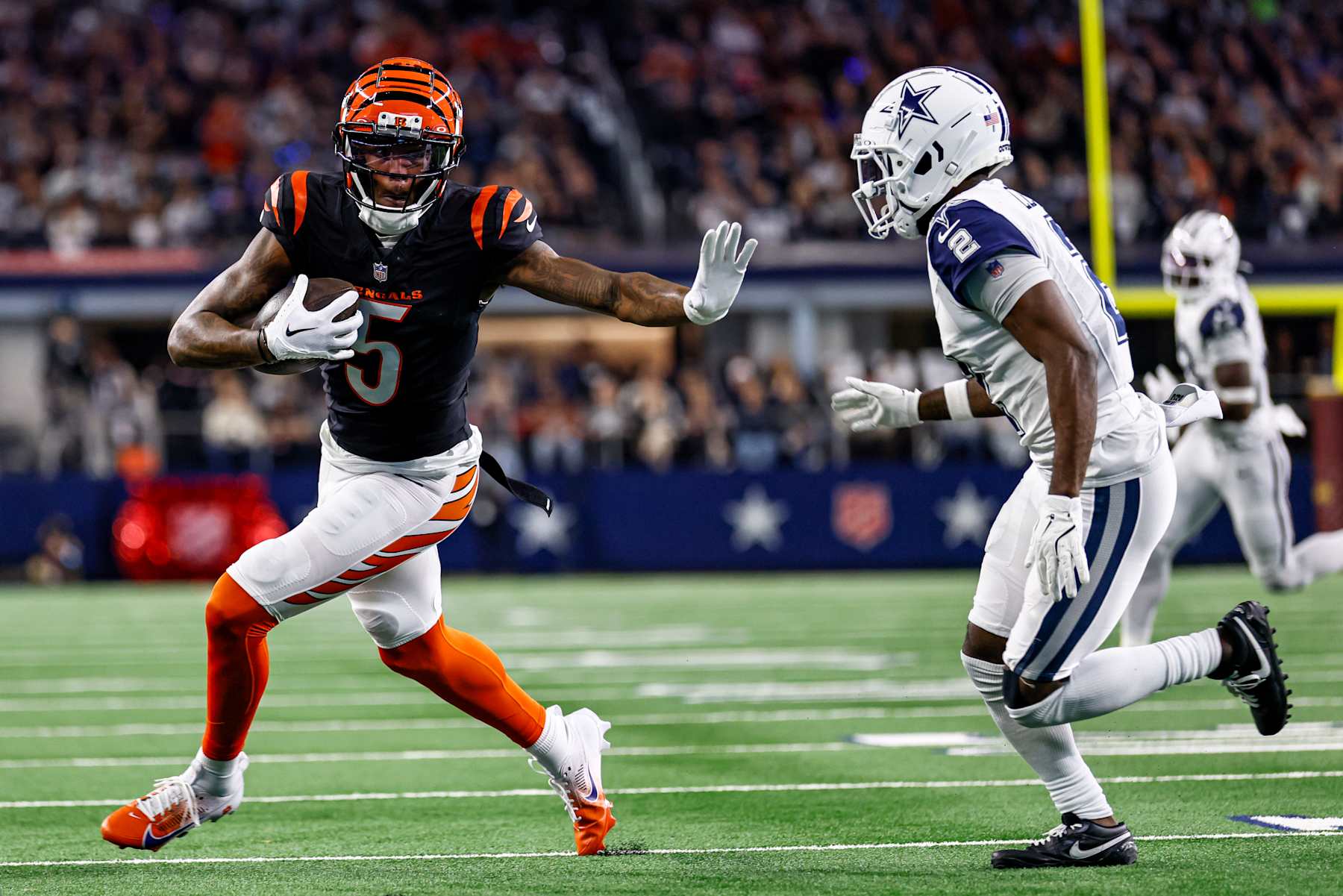 ARLINGTON, TX - DECEMBER 09: Cincinnati Bengals wide receiver Tee Higgins (5) stiff arms Dallas Cowboys cornerback Jourdan Lewis (2) during the game between the Dallas Cowboys and the Cincinnati Bengals on December 9, 2024 at AT&T Stadium in Arlington, Texas. (Photo by Matthew Pearce/Icon Sportswire via Getty Images)