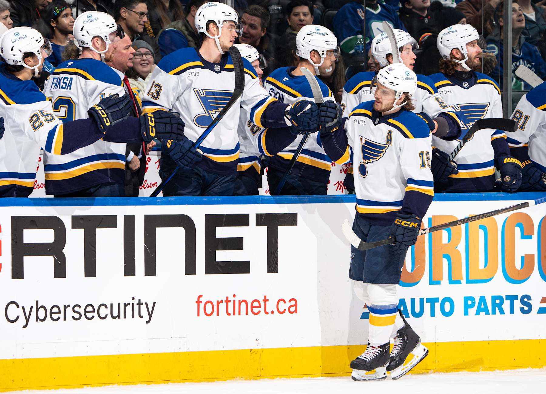VANCOUVER, CANADA - DECEMBER 10: Robert Thomas #18 of the St. Louis Blues celebrates his goal with teammates during the first period of their NHL game against the Vancouver Canucks at Rogers Arena on December 10, 2024 in Vancouver, British Columbia, Canada. (Photo by Jeff Vinnick/NHLI via Getty Images)