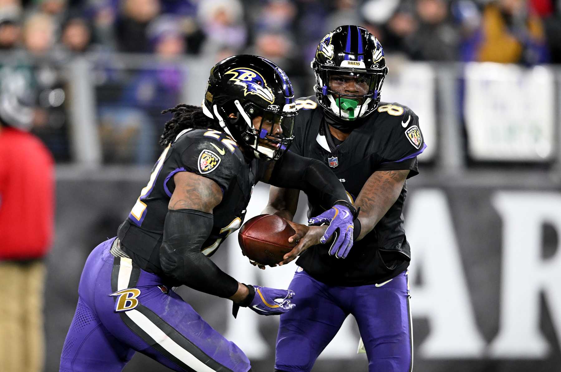 BALTIMORE, MARYLAND - DECEMBER 01: Lamar Jackson #8 of the Baltimore Ravens hands off the ball to Derrick Henry #22 during the game against the Philadelphia Eagles at M&T Bank Stadium on December 01, 2024 in Baltimore, Maryland. (Photo by G Fiume/Getty Images)