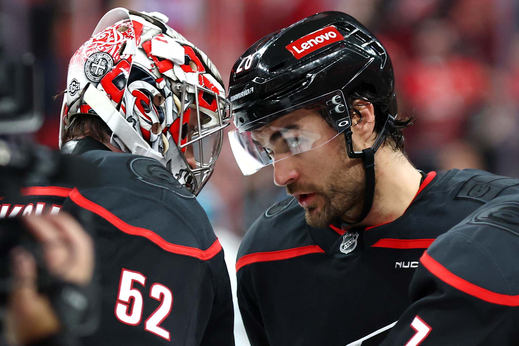 RALEIGH, NORTH CAROLINA - DECEMBER 10: Pyotr Kochetkov #52 of the Carolina Hurricanes is congratulated by teammate William Carrier #28 following their 3-2 victory over the San Jose Sharks at Lenovo Center on December 10, 2024 in Raleigh, North Carolina. (Photo by Jared C. Tilton/Getty Images)
