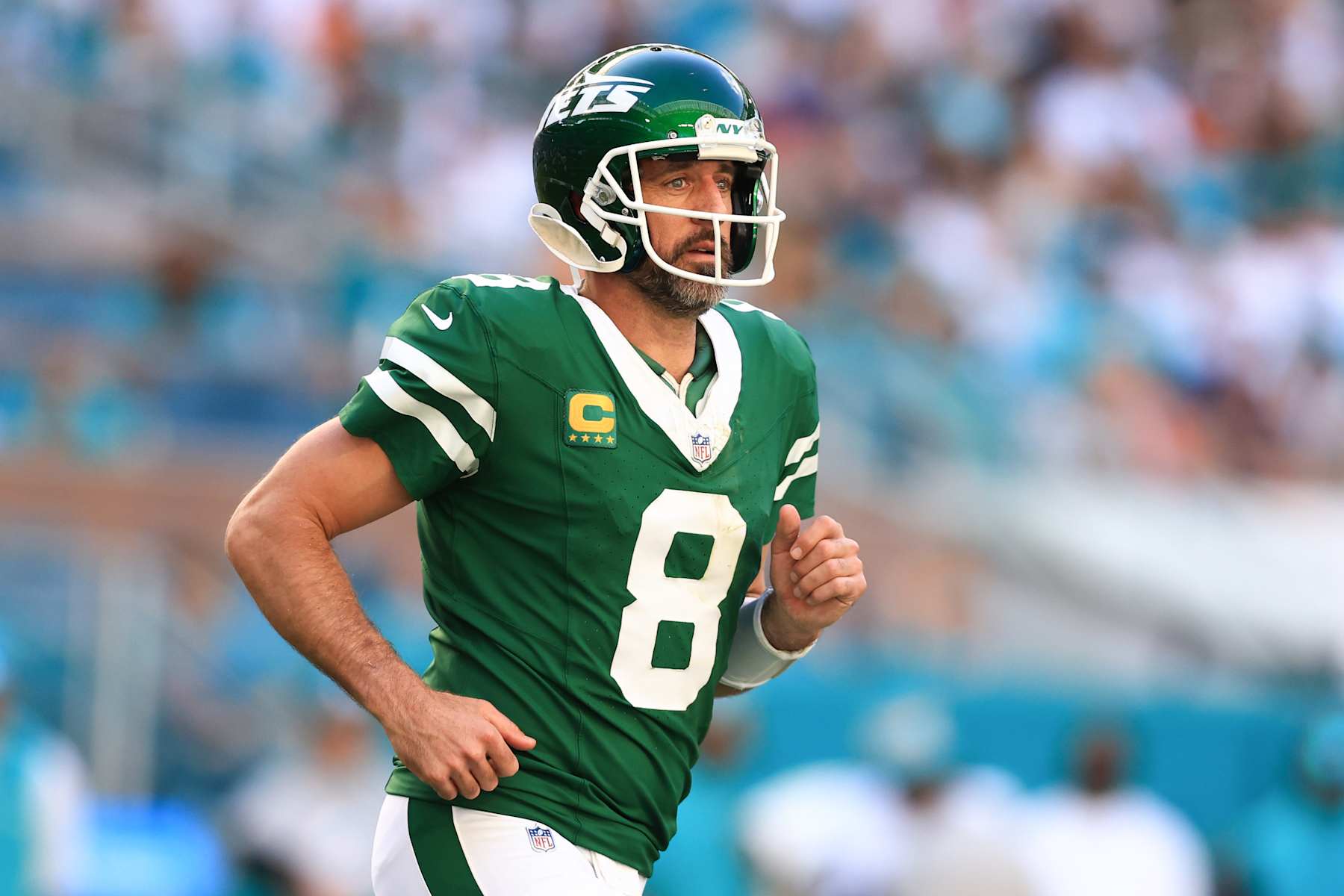 MIAMI GARDENS, FLORIDA - DECEMBER 08: Aaron Rodgers #8 of the New York Jets looks on against the Miami Dolphins during the first half of the game at Hard Rock Stadium on December 08, 2024 in Miami Gardens, Florida. (Photo by Megan Briggs/Getty Images)