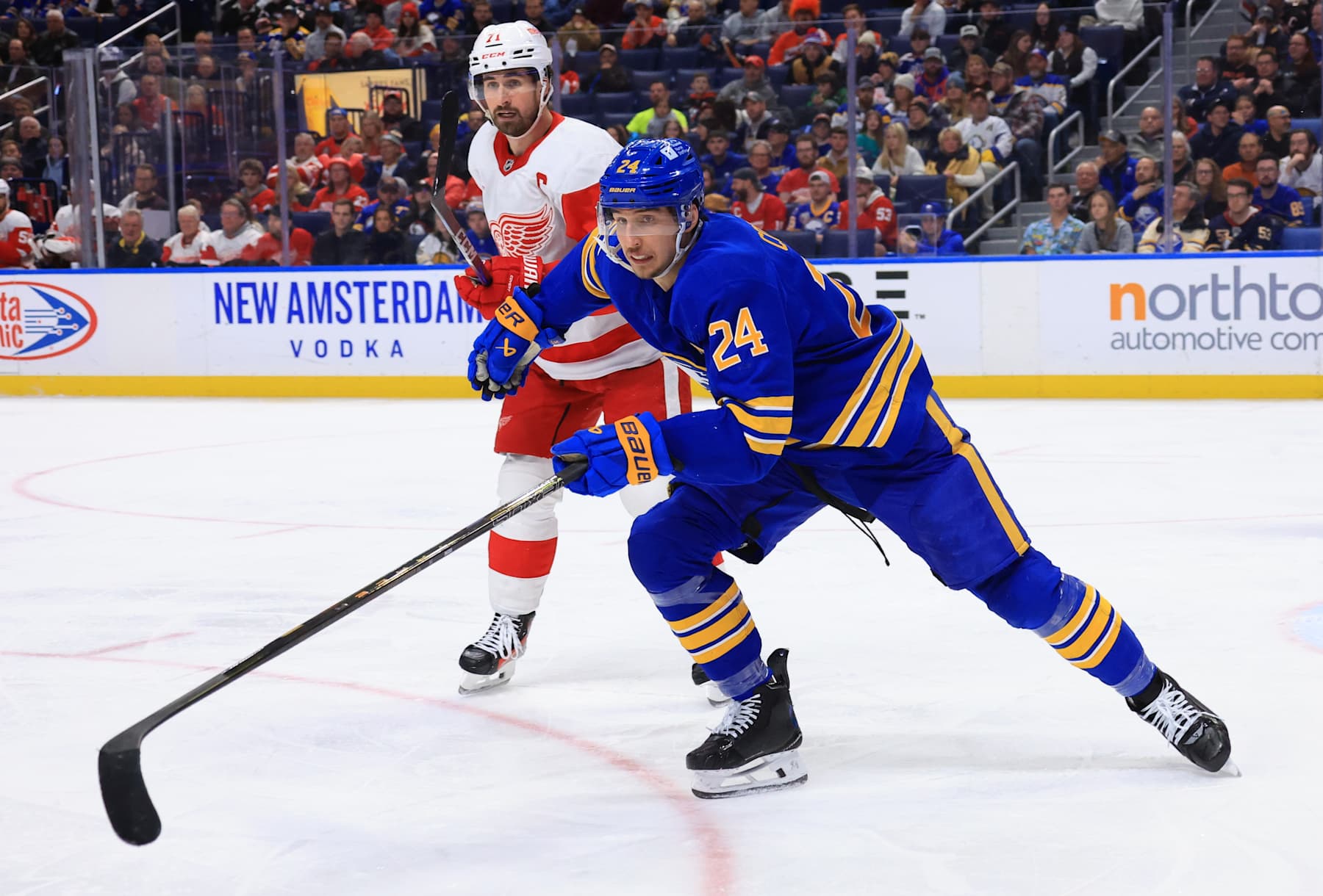 BUFFALO, NEW YORK - DECEMBER 9: Dylan Cozens #24 of the Buffalo Sabres skates against Dylan Larkin #71 of the Detroit Red Wings during an NHL game on December 9, 2024 at KeyBank Center in Buffalo, New York. (Photo by Bill Wippert/NHLI via Getty Images)