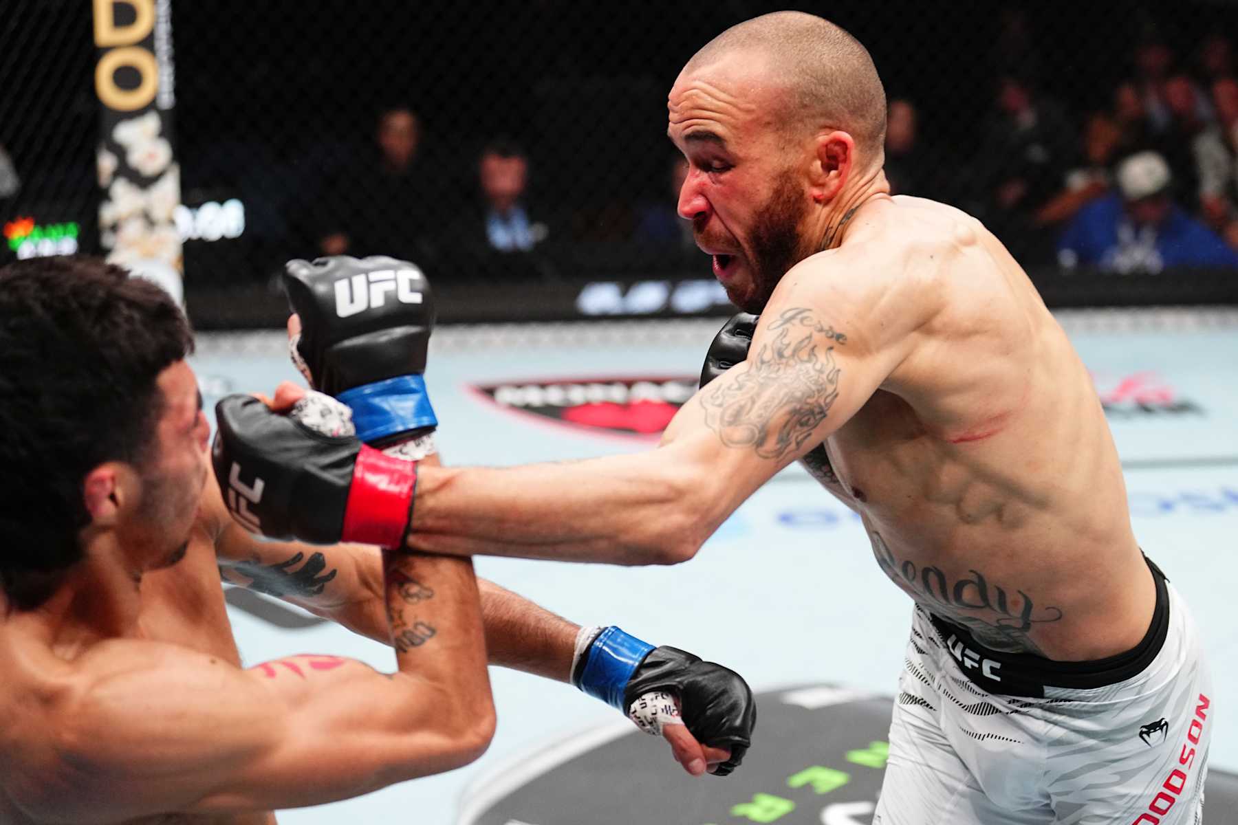 TAMPA, FLORIDA - DECEMBER 14: (R-L) Sean Woodson punches Fernando Padilla of Mexico in a featherweight fight during the UFC Fight Night event at Amalie Arena on December 14, 2024 in Tampa, Florida. (Photo by Chris Unger/Zuffa LLC)