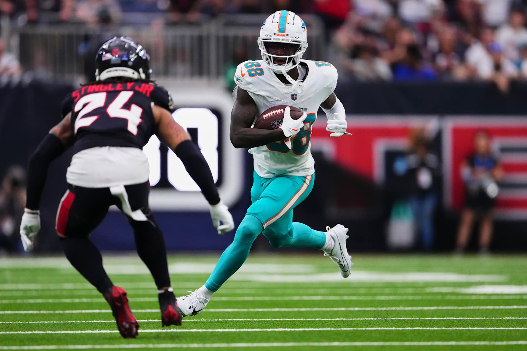 HOUSTON, TX - DECEMBER 15: Grant DuBose #88 of the Miami Dolphins runs with the ball against the Houston Texans during the first half of an NFL football game at NRG Stadium on December 15, 2024 in Houston, Texas. (Photo by Cooper Neill/Getty Images)