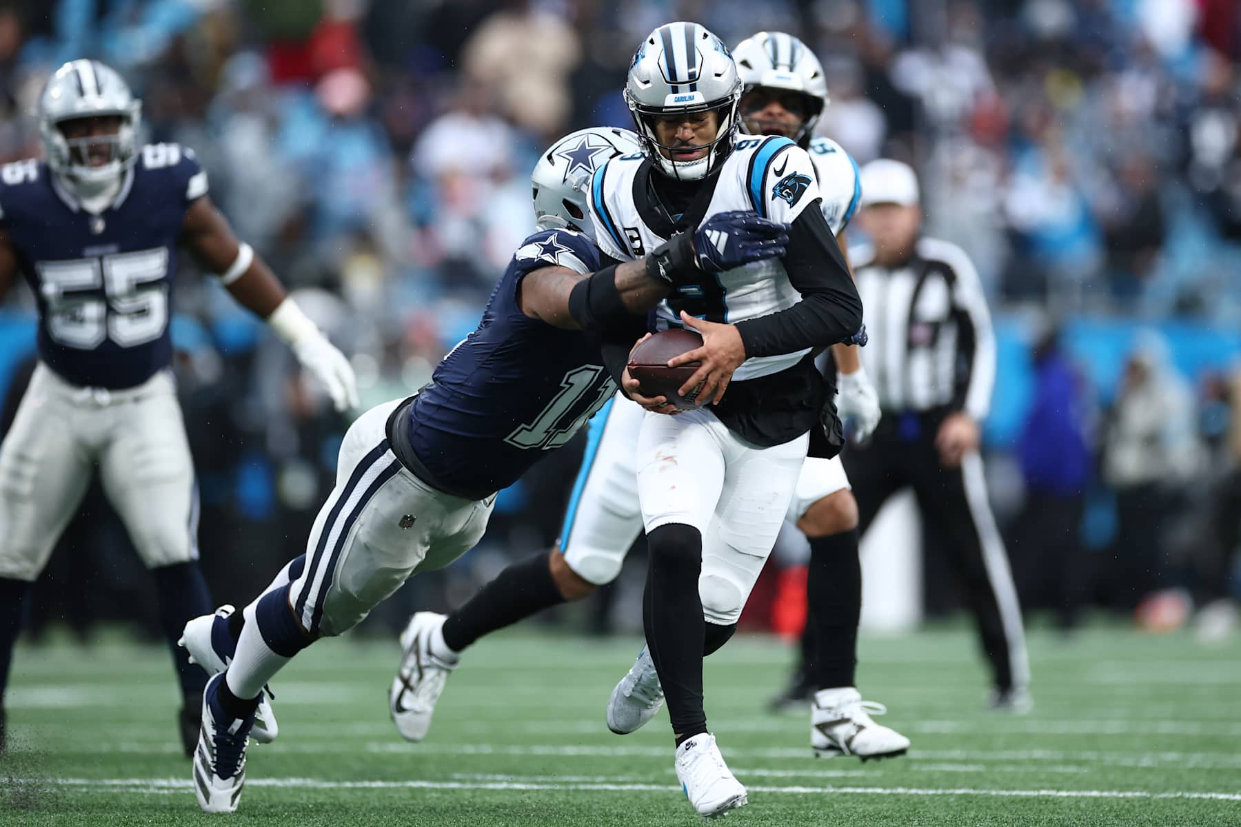 CHARLOTTE, NORTH CAROLINA - DECEMBER 15: Micah Parsons #11 of the Dallas Cowboys tackles Bryce Young #9 of the Carolina Panthers during the fourth quarter at Bank of America Stadium on December 15, 2024 in Charlotte, North Carolina. (Photo by Jared C. Tilton/Getty Images)