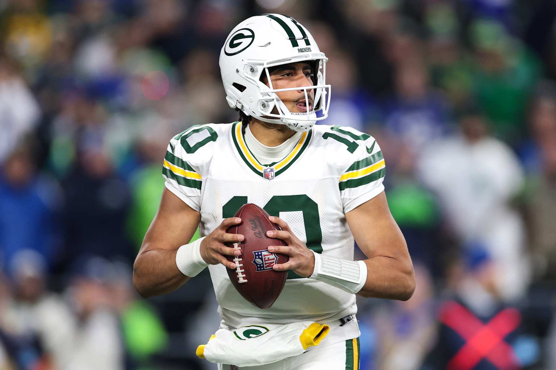 SEATTLE, WASHINGTON - DECEMBER 15: Jordan Love #10 of the Green Bay Packers looks to pass against the Seattle Seahawks during the first half of the game at Lumen Field on December 15, 2024 in Seattle, Washington. (Photo by Steph Chambers/Getty Images)