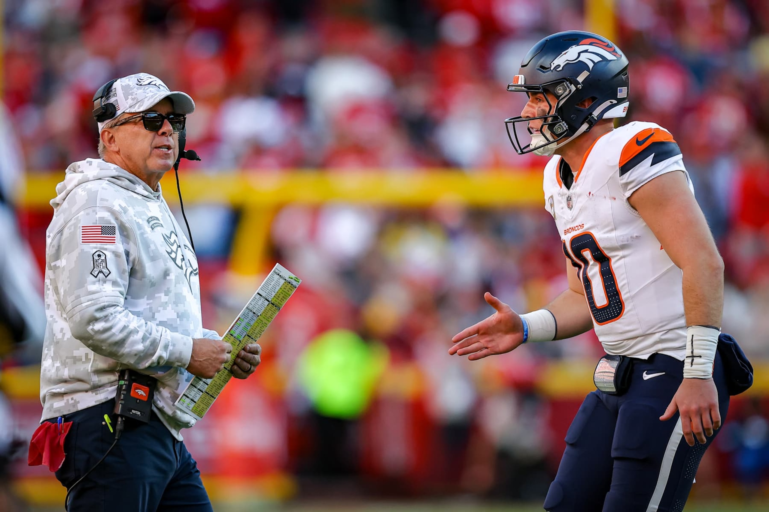 KANSAS CITY, MISSOURI - NOVEMBER 10: Bo Nix #10 of the Denver Broncos talks with head coach Sean payton during the final minute of the fourth quarter against the Kansas City Chiefs at GEHA Field at Arrowhead Stadium on November 10, 2024 in Kansas City, Missouri. (Photo by David Eulitt/Getty Images)