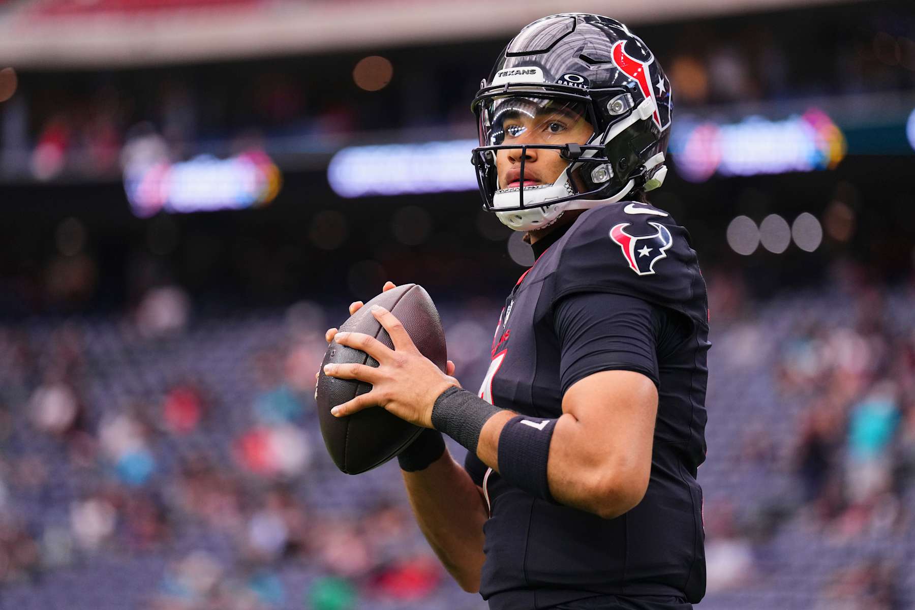 HOUSTON, TX - DECEMBER 15: C.J. Stroud #7 of the Houston Texans warms up before kickoff against the Miami Dolphins during an NFL football game at NRG Stadium on December 15, 2024 in Houston, Texas. (Photo by Cooper Neill/Getty Images)