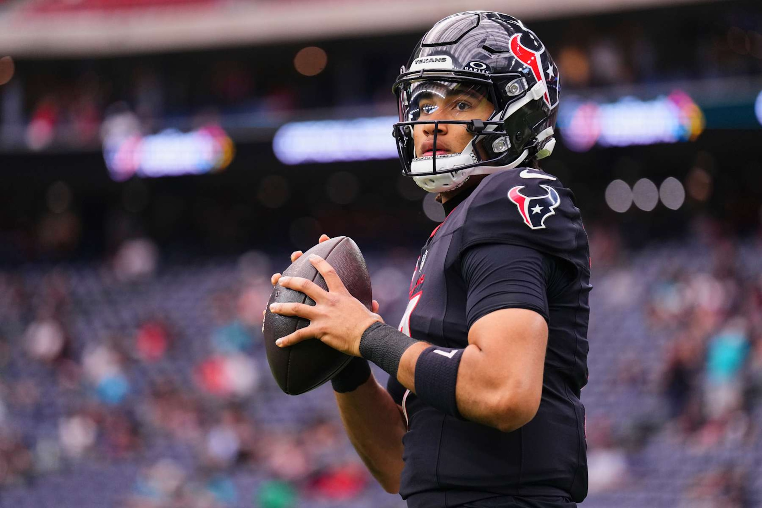 HOUSTON, TX - DECEMBER 15: C.J. Stroud #7 of the Houston Texans warms up before kickoff against the Miami Dolphins during an NFL football game at NRG Stadium on December 15, 2024 in Houston, Texas. (Photo by Cooper Neill/Getty Images)