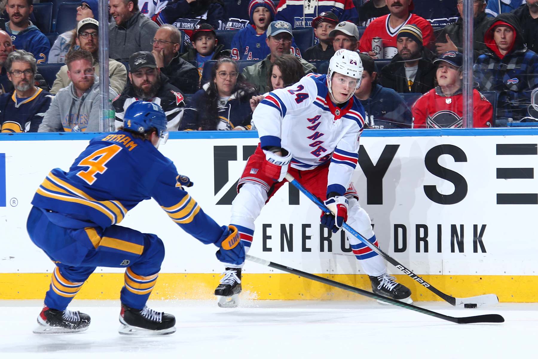 BUFFALO, NEW YORK - DECEMBER 11: Kaapo Kakko #24 of the New York Rangers controls the puck against Bowen Byram #4 of the Buffalo Sabres during an NHL game on December 11, 2024 at KeyBank Center in Buffalo, New York. (Photo by Bill Wippert/NHLI via Getty Images)