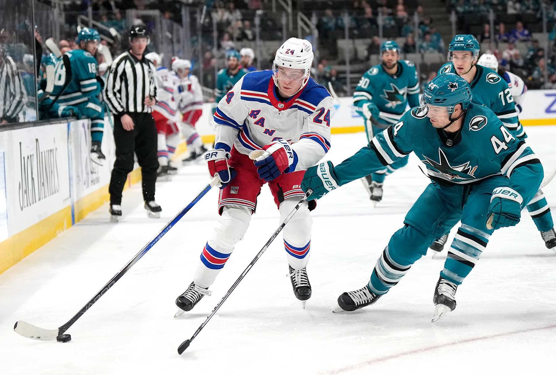 SAN JOSE, CALIFORNIA - JANUARY 23: Kaapo Kakko #24 of the New York Rangers skates up ice with the puck defended by Marc-Edouard Vlasic during the first period at SAP Center on January 23, 2024 in San Jose, California. (Photo by Thearon W. Henderson/Getty Images)