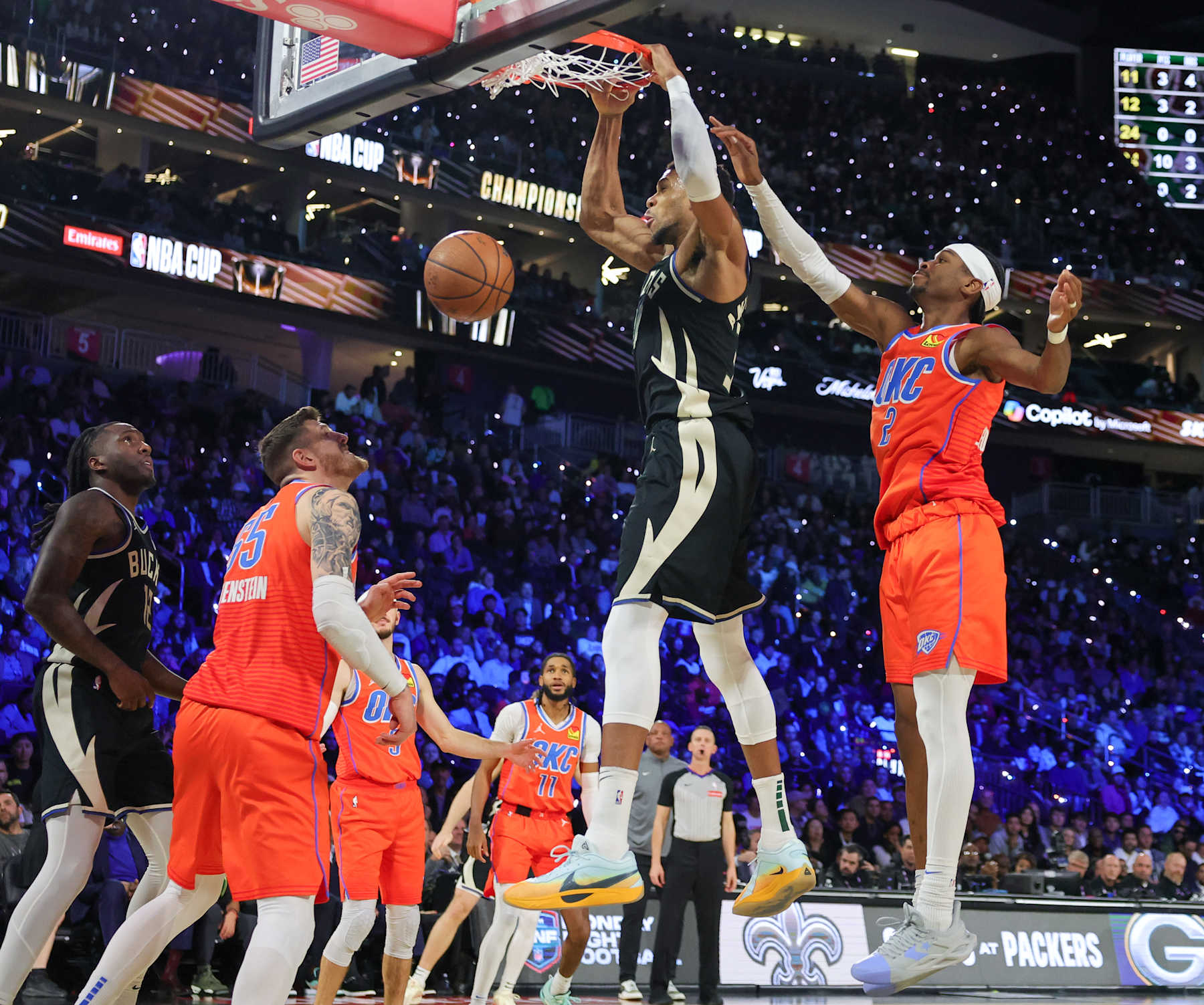 LAS VEGAS, NEVADA - DECEMBER 17: Giannis Antetokounmpo #34 of the Milwaukee Bucks dunks ahead of Shai Gilgeous-Alexander #2 of the Oklahoma City Thunder in the second quarter of the championship game of the Emirates NBA Cup at T-Mobile Arena on December 17, 2024 in Las Vegas, Nevada. NOTE TO USER: User expressly acknowledges and agrees that, by downloading and or using this photograph, User is consenting to the terms and conditions of the Getty Images License Agreement. (Photo by Ethan Miller/Getty Images)