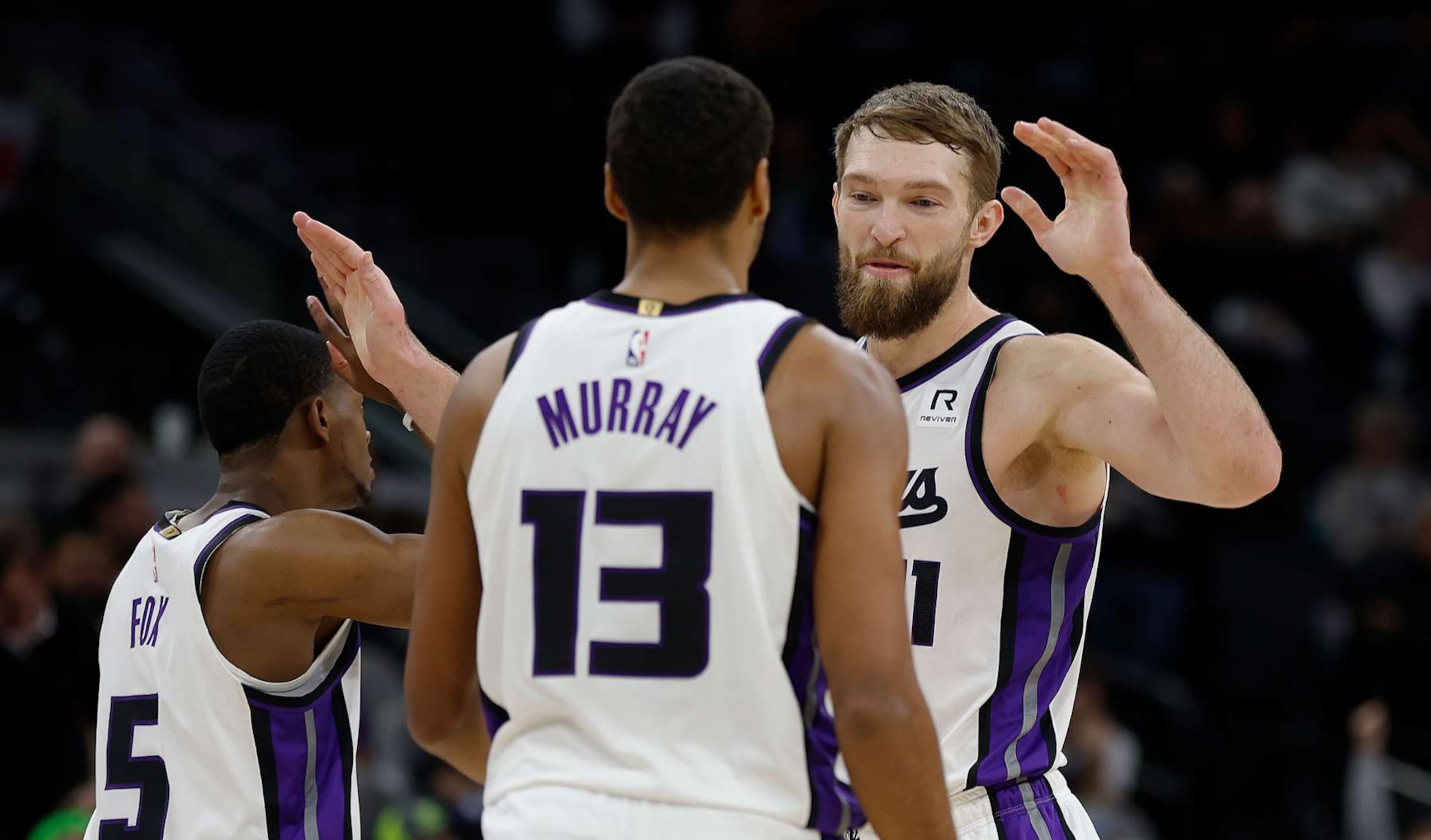 SAN ANTONIO, TX - DECEMBER 6:  Domantas Sabonis #11 of the Sacramento Kings high fives Keegan Murray and De'Aaron Fox in closing minutes of their game against the San Antonio Spurs  at Frost Bank Center on December 6, 2024 in San Antonio, Texas. NOTE TO USER: User expressly acknowledges and agrees that, by downloading and or using this photograph, User is consenting to terms and conditions of the Getty Images License Agreement. (Photo by Ronald Cortes/Getty Images)