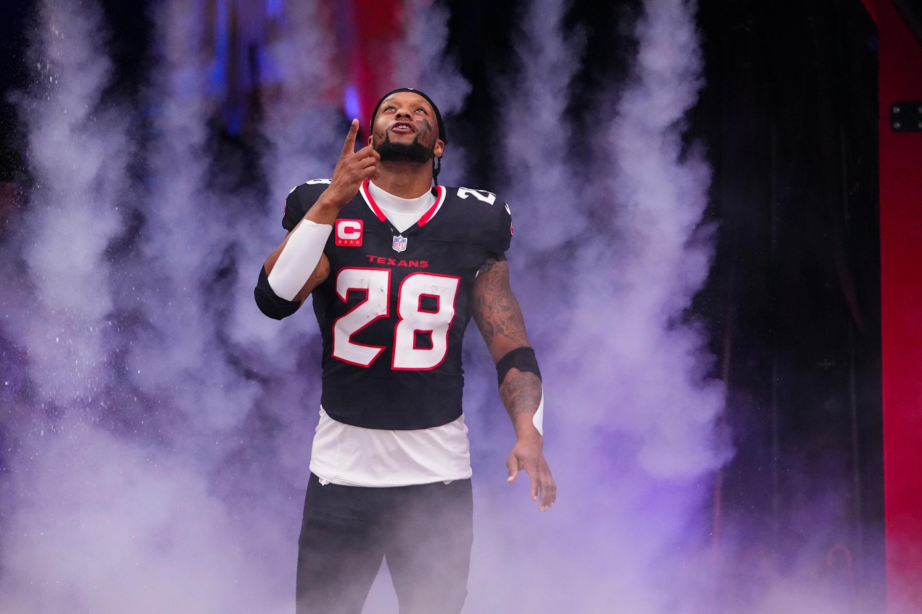 HOUSTON, TX - DECEMBER 15: Joe Mixon #28 of the Houston Texans runs out of the tunnel prior to an NFL football game against the Miami Dolphins at NRG Stadium on December 15, 2024 in Houston, Texas. (Photo by Cooper Neill/Getty Images)