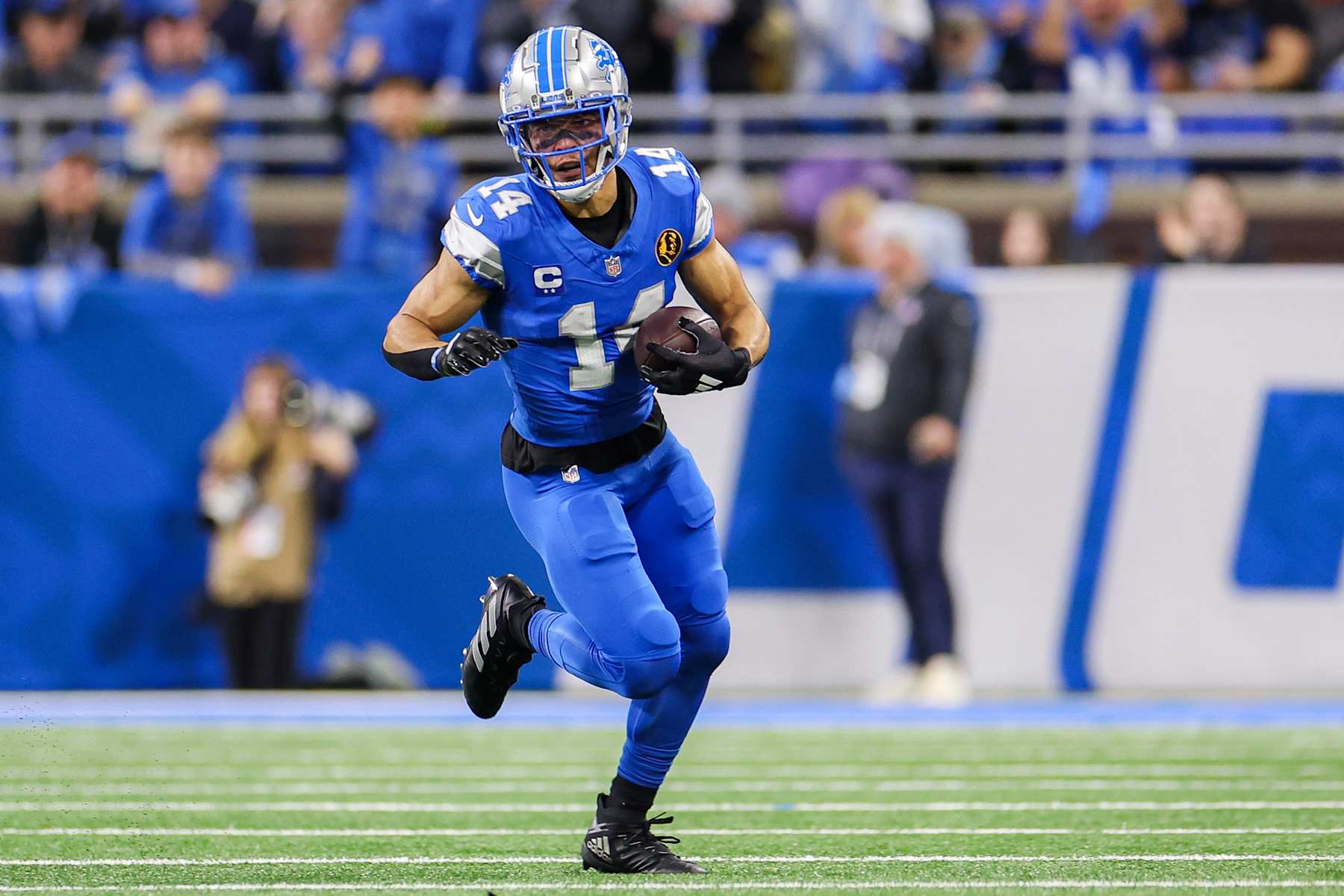 DETROIT, MICHIGAN - NOVEMBER 28: Amon-Ra St. Brown #14 of the Detroit Lions runs the ball up the field after catching a pass during the first half of a game against the Chicago Bears at Ford Field on November 28, 2024 in Detroit, Michigan. (Photo by Mike Mulholland/Getty Images)