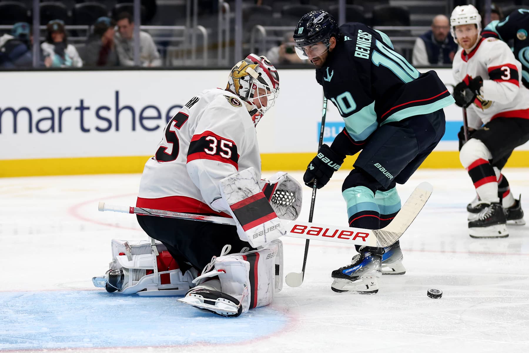 SEATTLE, WASHINGTON - DECEMBER 17: Linus Ullmark #35 of the Ottawa Senators makes a save against Matty Beniers #10 of the Seattle Kraken during the second period at Climate Pledge Arena on December 17, 2024 in Seattle, Washington. Beniers is skating in his 200th career NHL game. (Photo by Steph Chambers/Getty Images)