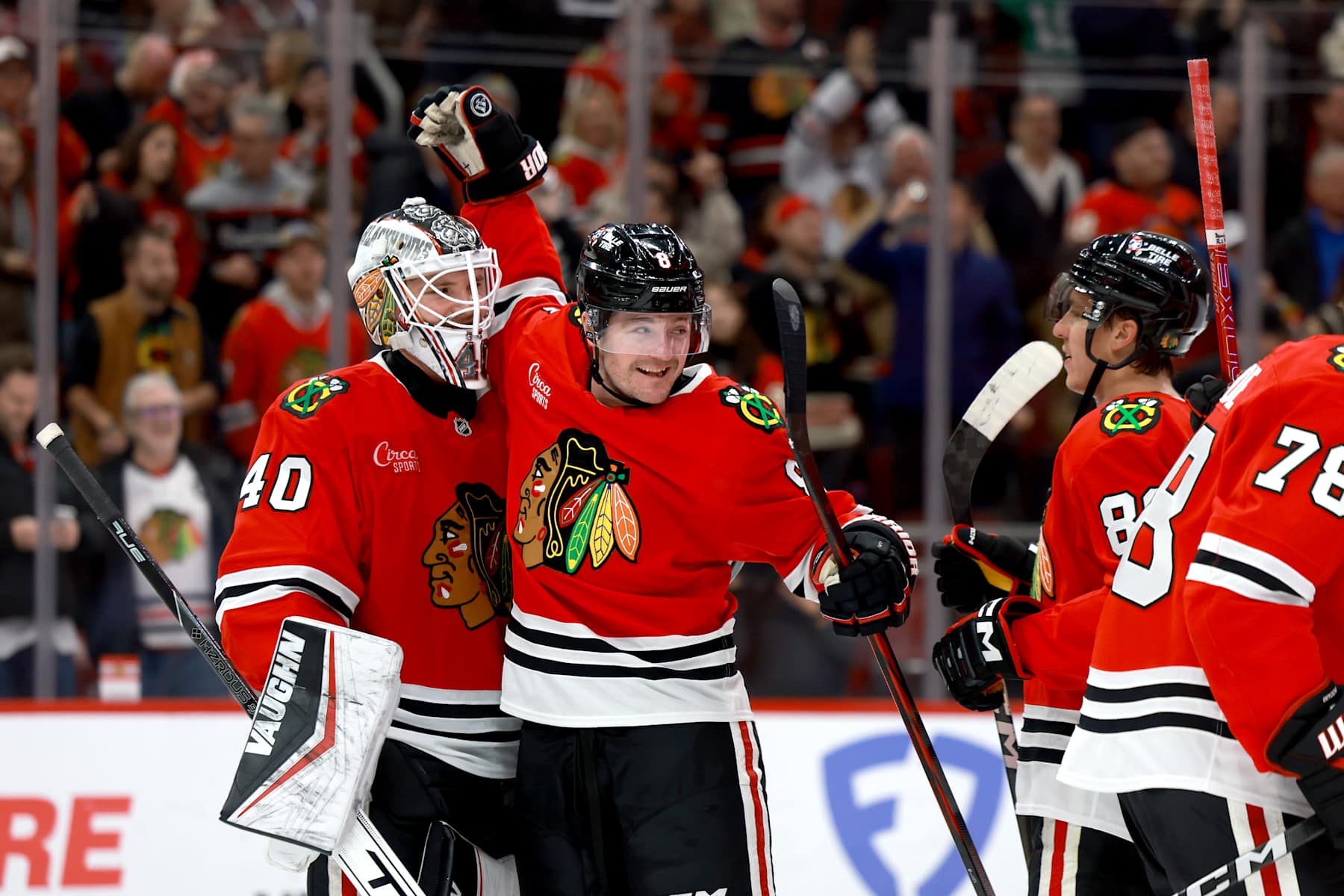 CHICAGO, ILLINOIS - DECEMBER 17: Ryan Donato #8 of the Chicago Blackhawks celebrates with teammate goalie Arvid Soderblom #40 after defeating the Washington Capitals 3-2 at the United Center on December 17, 2024 in Chicago, Illinois. (Photo by Chase Agnello-Dean/NHLI via Getty Images)