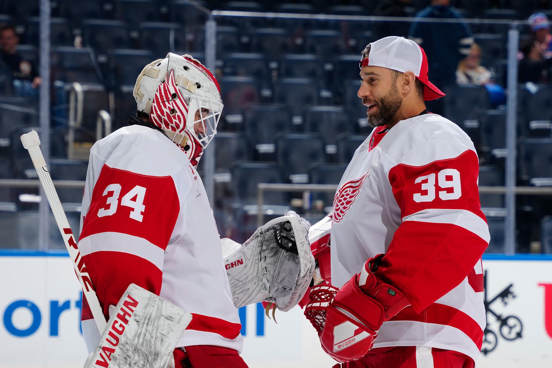 ELMONT, NEW YORK - OCTOBER 22: Alex Lyon #34 and Cam Talbot #39 of the Detroit Red Wings celebrate their 1-0 win against the New York Islanders at UBS Arena on October 22, 2024 in Elmont, New York. (Photo by Mike Stobe/NHLI via Getty Images)