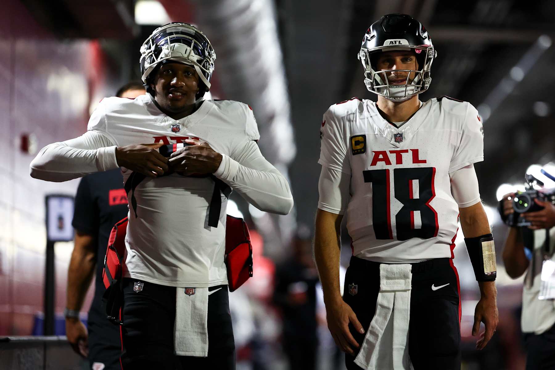TAMPA, FLORIDA - OCTOBER 27: Michael Penix Jr. #9 and Kirk Cousins #18 of the Atlanta Falcons walk through the tunnel prior to an NFL football game against the Tampa Bay Buccaneers at Raymond James Stadium on October 27, 2024 in Tampa, Florida. (Photo by Kevin Sabitus/Getty Images)