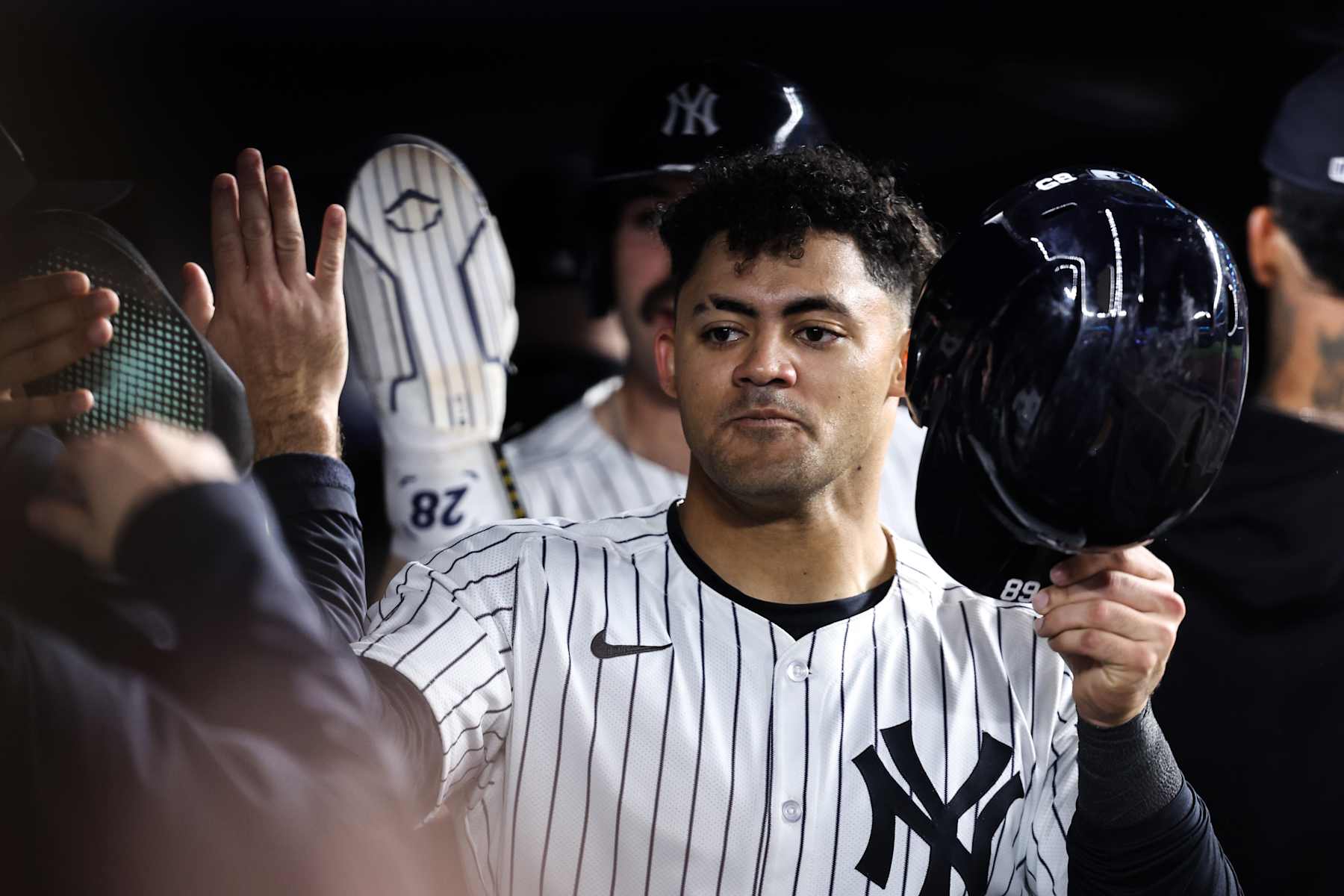 NEW YORK, NEW YORK - SEPTEMBER 29: Jasson Domínguez #89 of the New York Yankees high fives teammates in the dugout after scoring a run during the eighth inning of the game against the Pittsburgh Pirates at Yankee Stadium on September 29, 2024 in New York City. (Photo by Dustin Satloff/Getty Images)