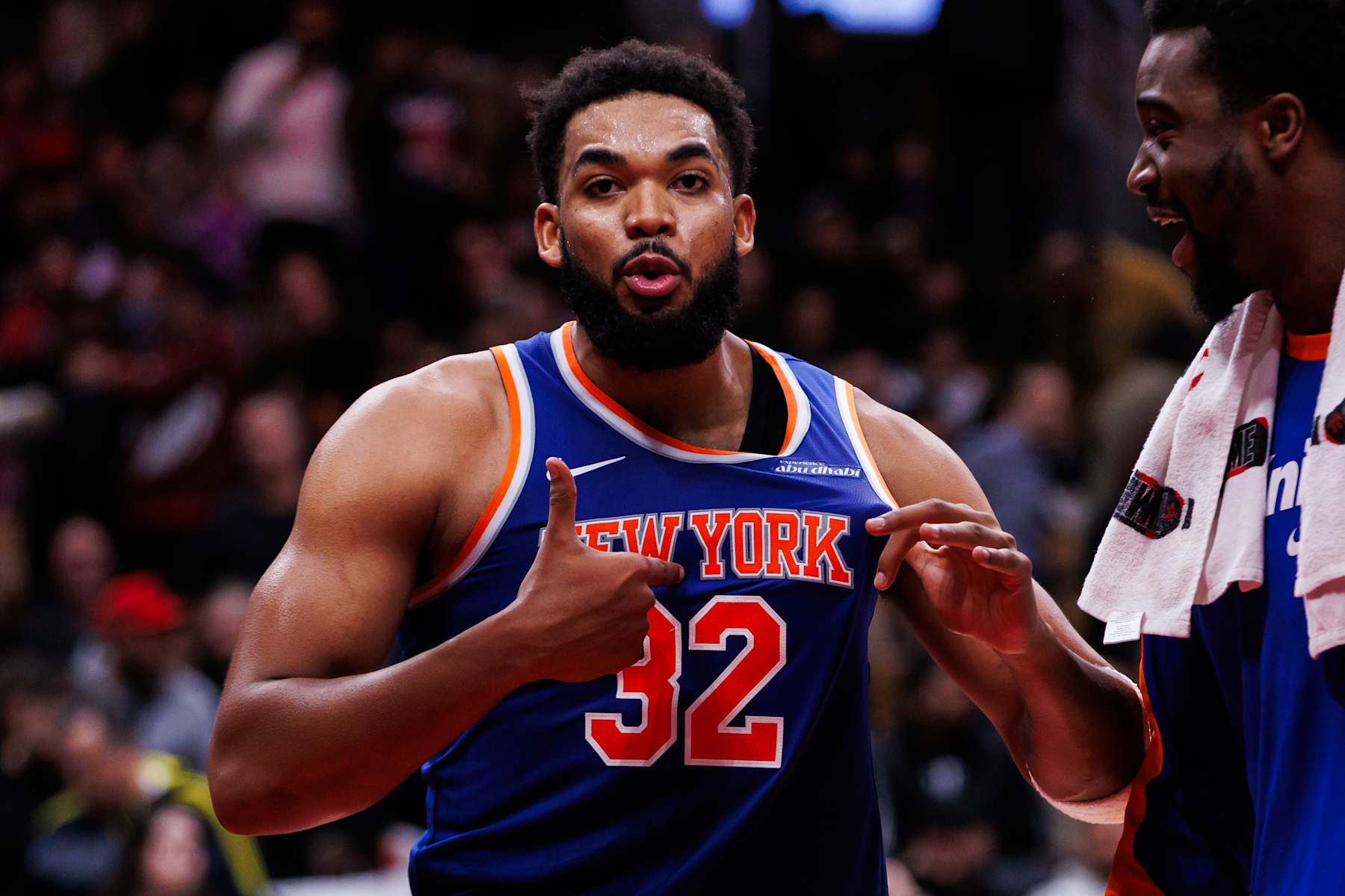 TORONTO, CANADA - DECEMBER 9: Karl-Anthony Towns #32 of the New York Knicks points to his jersey as he celebrates a basket during second half of their NBA game against the Toronto Raptors at Scotiabank Arena on December 9, 2024 in Toronto, Canada. NOTE TO USER: User expressly acknowledges and agrees that, by downloading and or using this photograph, User is consenting to the terms and conditions of the Getty Images License Agreement. (Photo by Cole Burston/Getty Images)