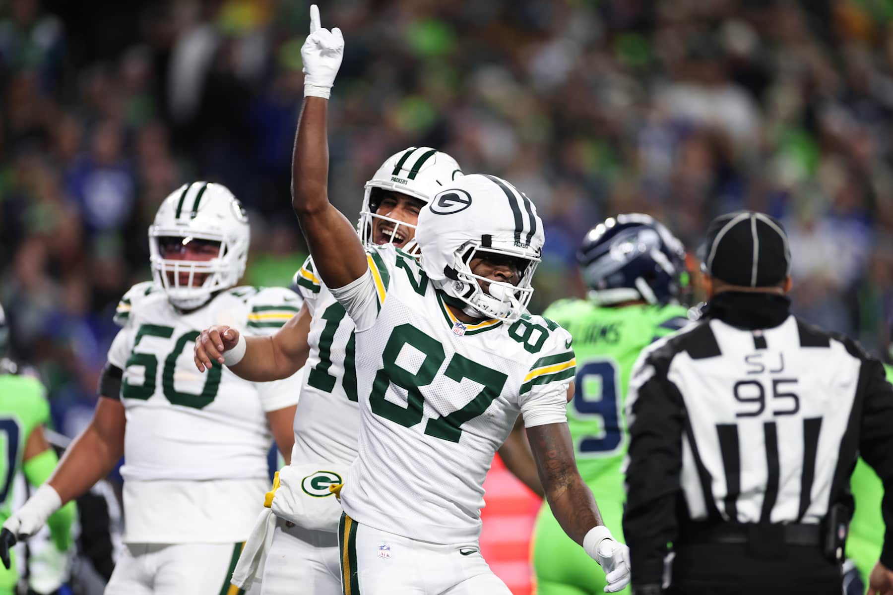 SEATTLE, WASHINGTON - DECEMBER 15: Romeo Doubs #87 of the Green Bay Packers celebrates with teammate Jordan Love #10 after scoring a touchdown against the Seattle Seahawks during the first quarter of the game at Lumen Field on December 15, 2024 in Seattle, Washington. (Photo by Steph Chambers/Getty Images)