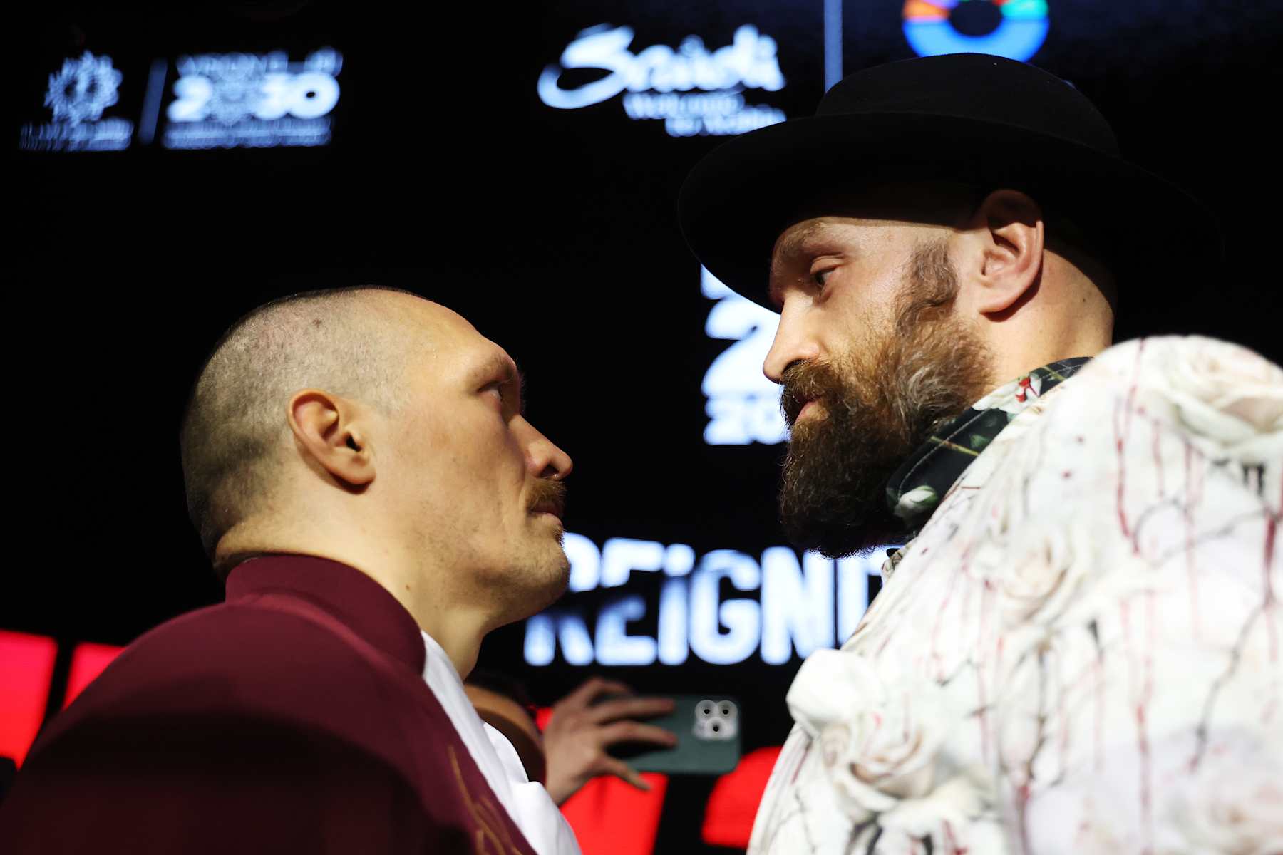 RIYADH, SAUDI ARABIA - DECEMBER 19: Tyson Fury (R) and Oleksandr Usyk face off ahead of the IBF, IBO, WBA, WBC and WBO Undisputed World Heavyweight Title fight between Oleksandr Usyk and Tyson Fury during a press conference as part of Oleksandr Usyk v Tyson Fury 2 at Via Riyadh on December 19, 2024 in Riyadh, Saudi Arabia. (Photo by Richard Pelham/Getty Images)
