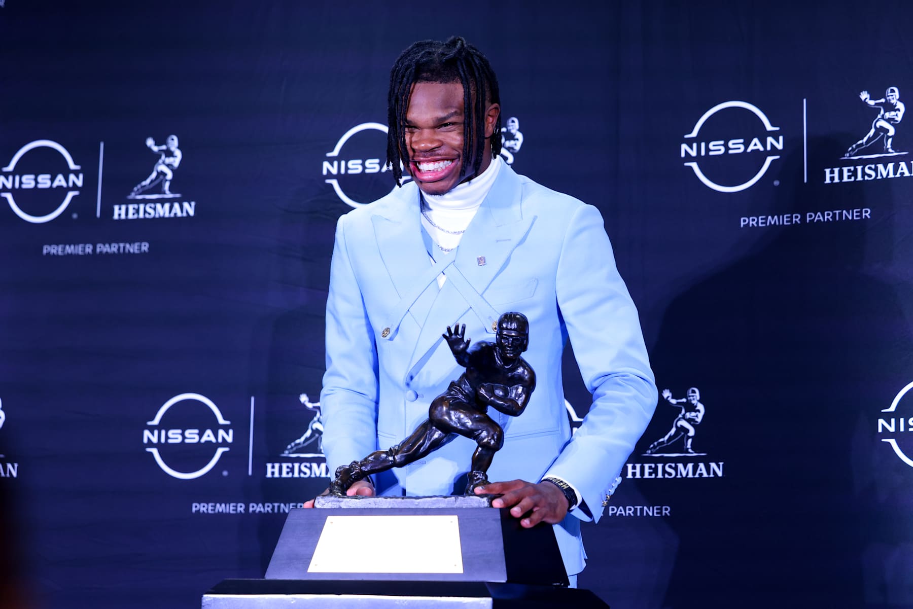 NEW YORK, NY - DECEMBER 14: Travis Hunter University of Colorado cornerback/wide receiver poses with the Trophy during the Heisman Trophy press conference at the Marriott Marquis on December 14, 2024 in New York, New York. (Photo by Rich Graessle/Icon Sportswire via Getty Images)
