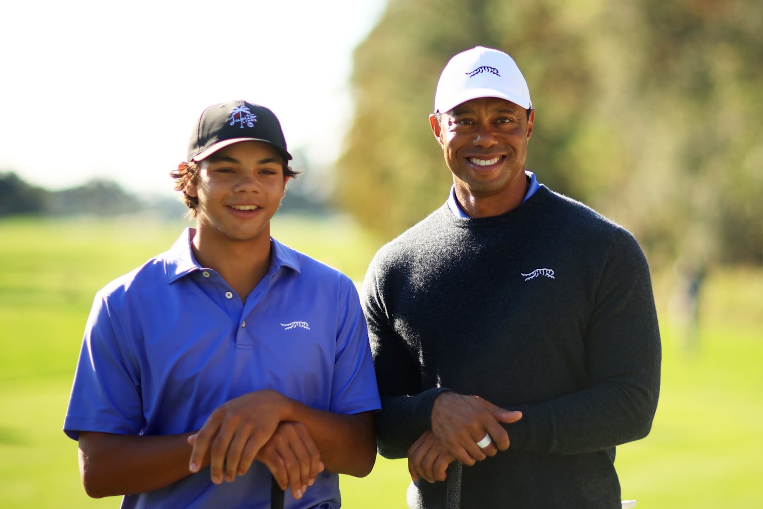 ORLANDO, FLORIDA - DECEMBER 20: Tiger Woods of the United States and son Charlie Woods pose for a photo during the pro-am prior to the PNC Championship at Ritz-Carlton Golf Club on December 20, 2024 in Orlando, Florida. (Photo by Mike Ehrmann/Getty Images)