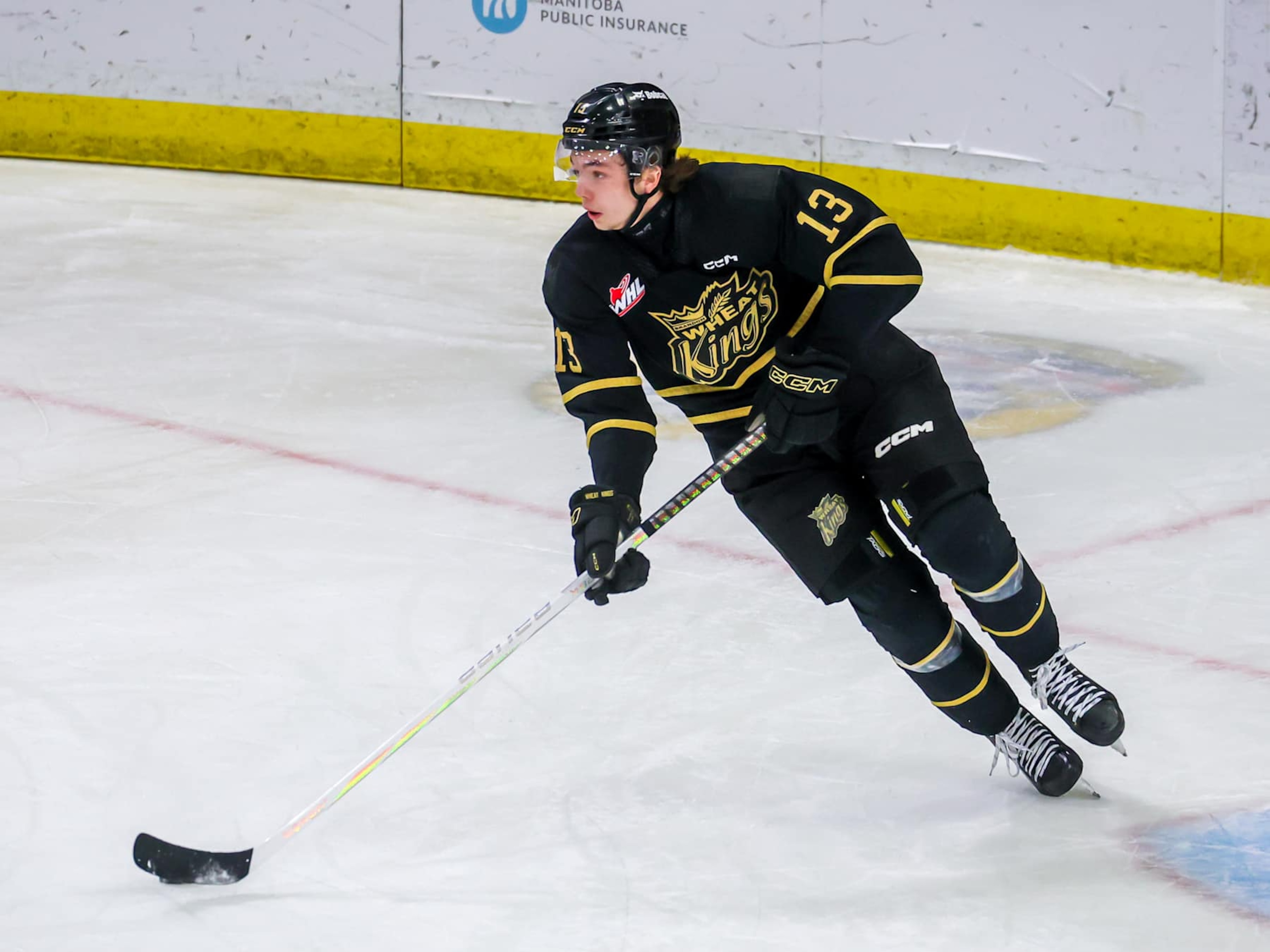 BRANDON, CANADA - APRIL 03: Roger McQueen #13 of the Brandon Wheat Kings plays the puck during first period action against the Moose Jaw Warriors in Game Three of the First Round of the 2024 WHL Playoffs at Westoba Place on April 03, 2024 in Brandon, Manitoba, Canada. (Photo by Jonathan Kozub/Getty Images) BRANDON, CANADA - APRIL 03: Roger McQueen #13 of the Brandon Wheat Kings plays the puck during first period action against the Moose Jaw Warriors in Game Three of the First Round of the 2024 WHL Playoffs at Westoba Place on April 03, 2024 in Brandon, Manitoba, Canada. (Photo by Jonathan Kozub/Getty Images)