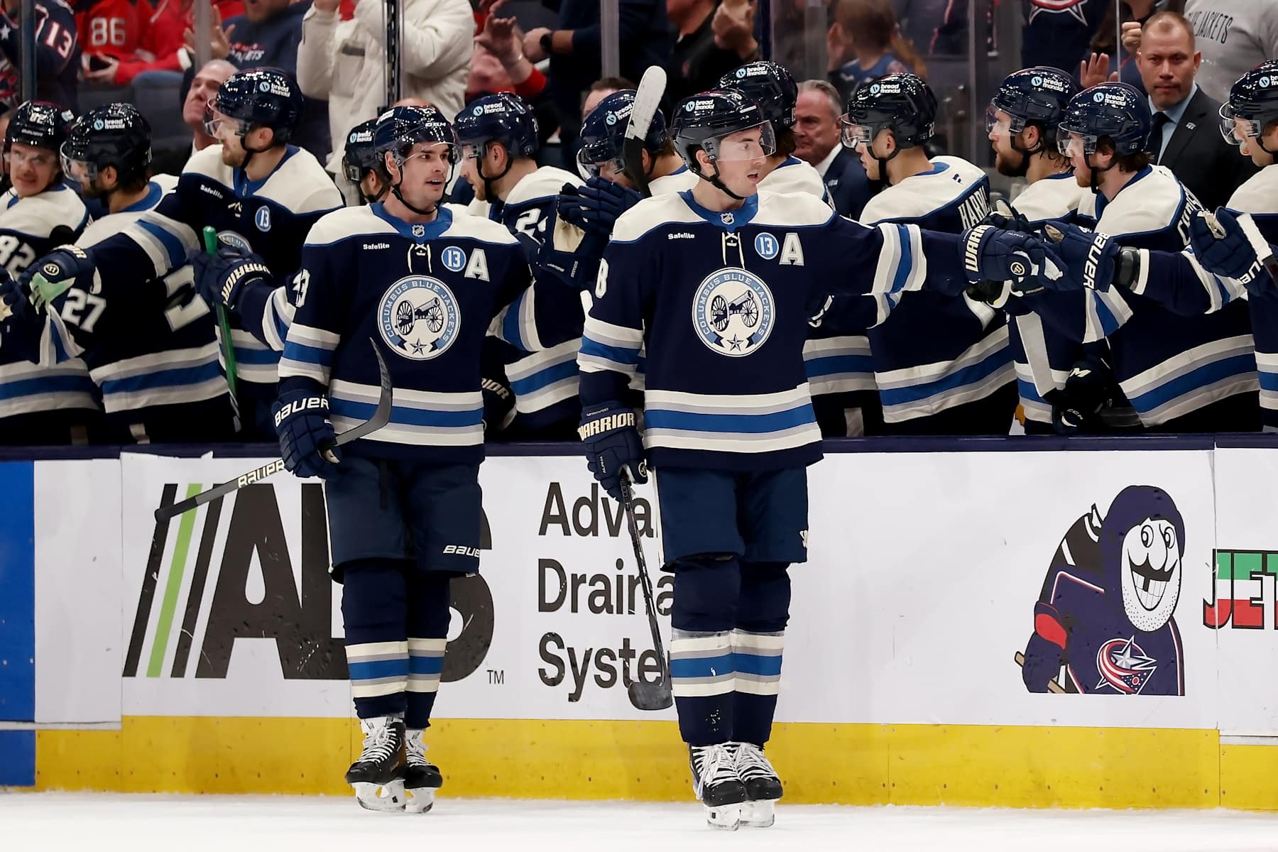 COLUMBUS, OHIO - DECEMBER 19: Zach Werenski #8 of the Columbus Blue Jackets is congratulated by his teammates after scoring a goal during the second period of the game against the New Jersey Devils at Nationwide Arena on December 19, 2024 in Columbus, Ohio. (Photo by Kirk Irwin/NHLI via Getty Images)