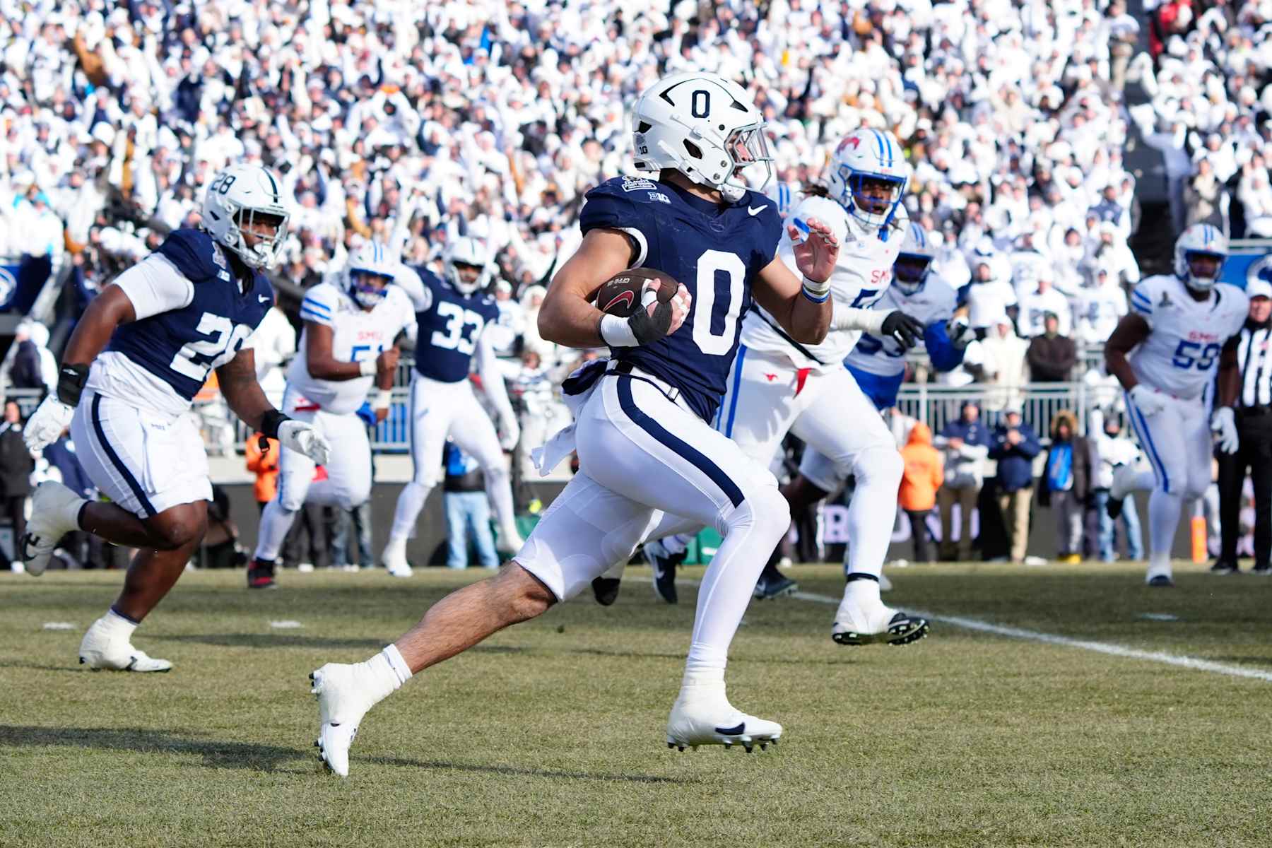 UNIVERSITY PARK, PA - DECEMBER 21: Penn State Nittany Lions Linebacker Dominic DeLuca (0) runs with the ball for a touchdown after intercepting a pass during the first half of the College Football Playoff First Round game between the SMU Mustangs and the Penn State Nittany Lions on December 21, 2024, at Beaver Stadium in University Park, PA. (Photo by Gregory Fisher/Icon Sportswire via Getty Images)