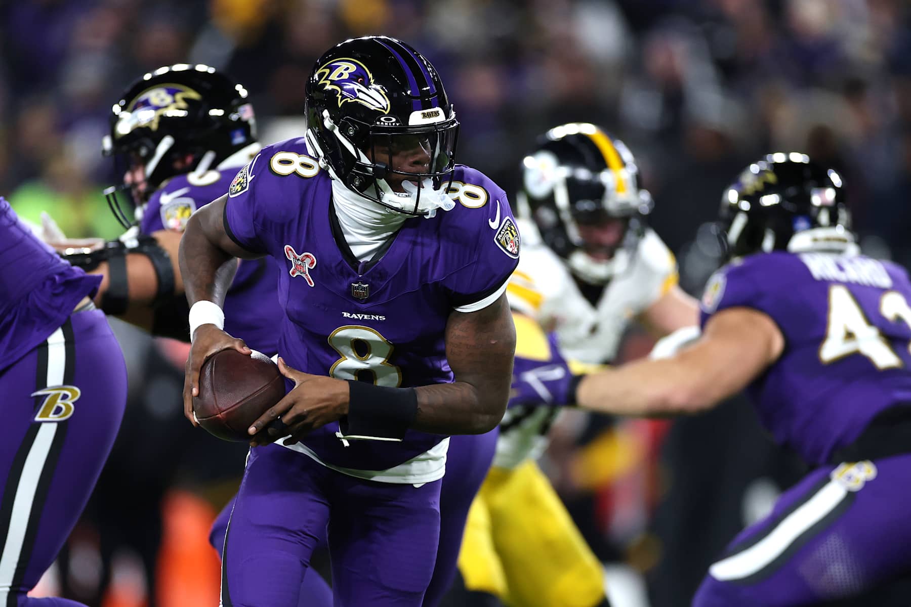 BALTIMORE, MARYLAND - DECEMBER 21: Lamar Jackson #8 of the Baltimore Ravens looks to hand off during the second quarter against the Pittsburgh Steelers at M&T Bank Stadium on December 21, 2024 in Baltimore, Maryland. (Photo by Patrick Smith/Getty Images)